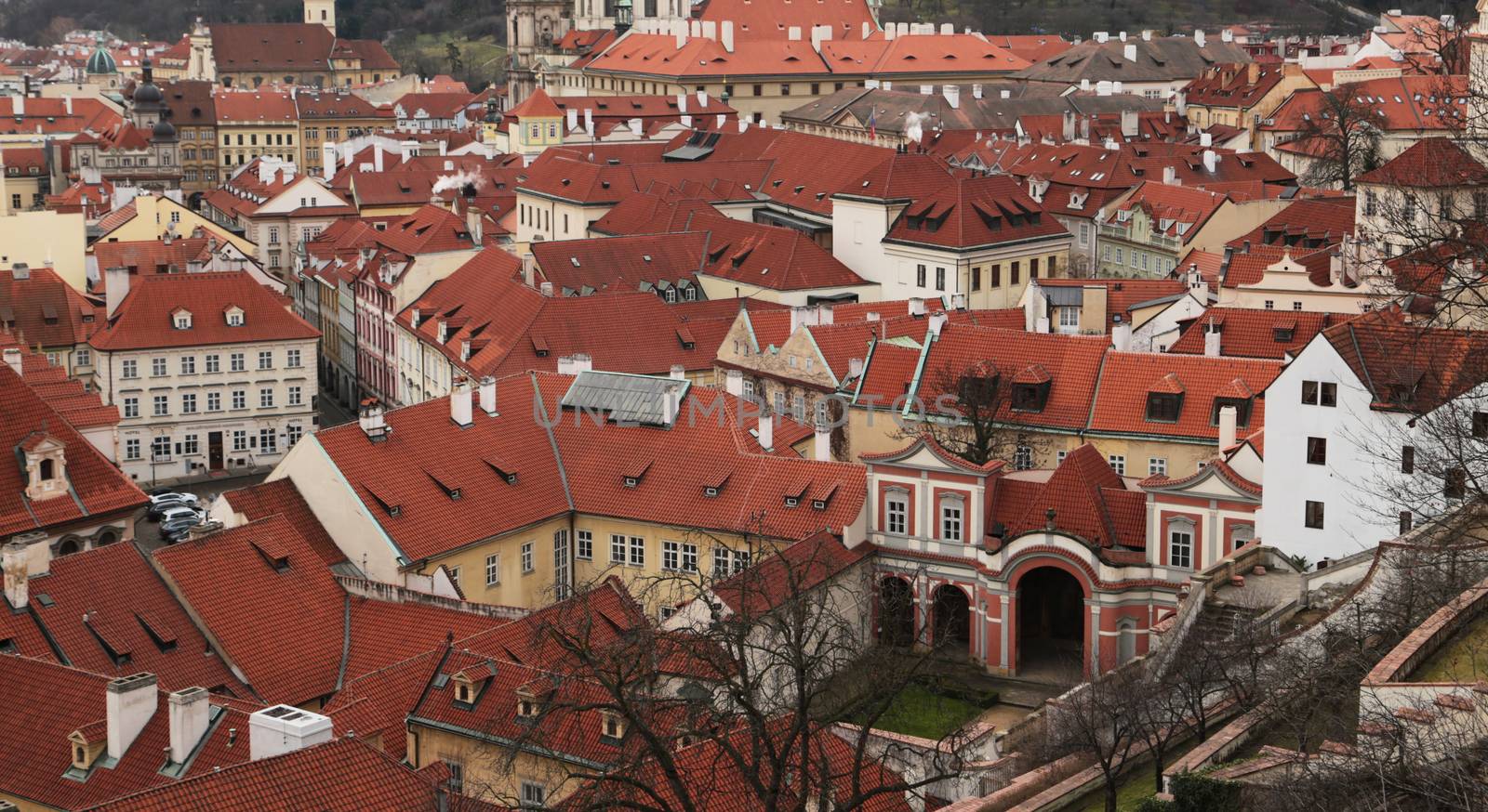 Prague roof tops. Aerial view of old terracotta houses in Prague from top of city hall. Famous European destination, cityescape. Top view