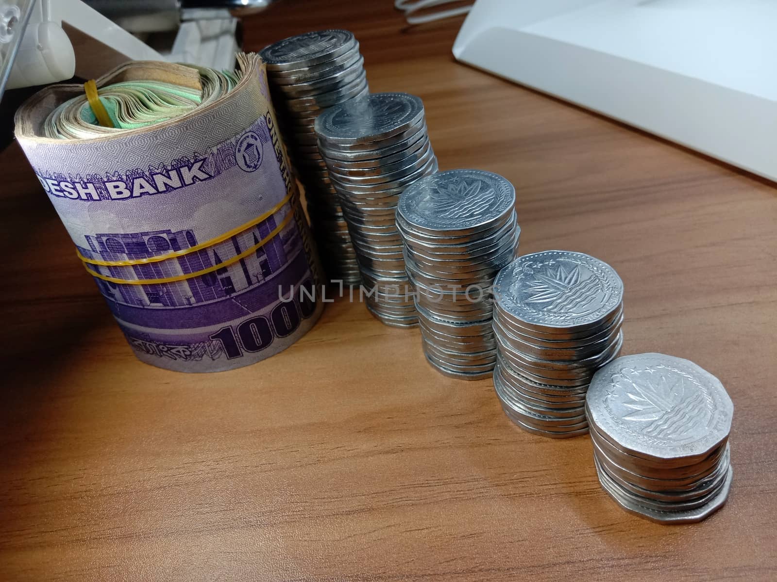 bangladeshi bank note and coin on white background