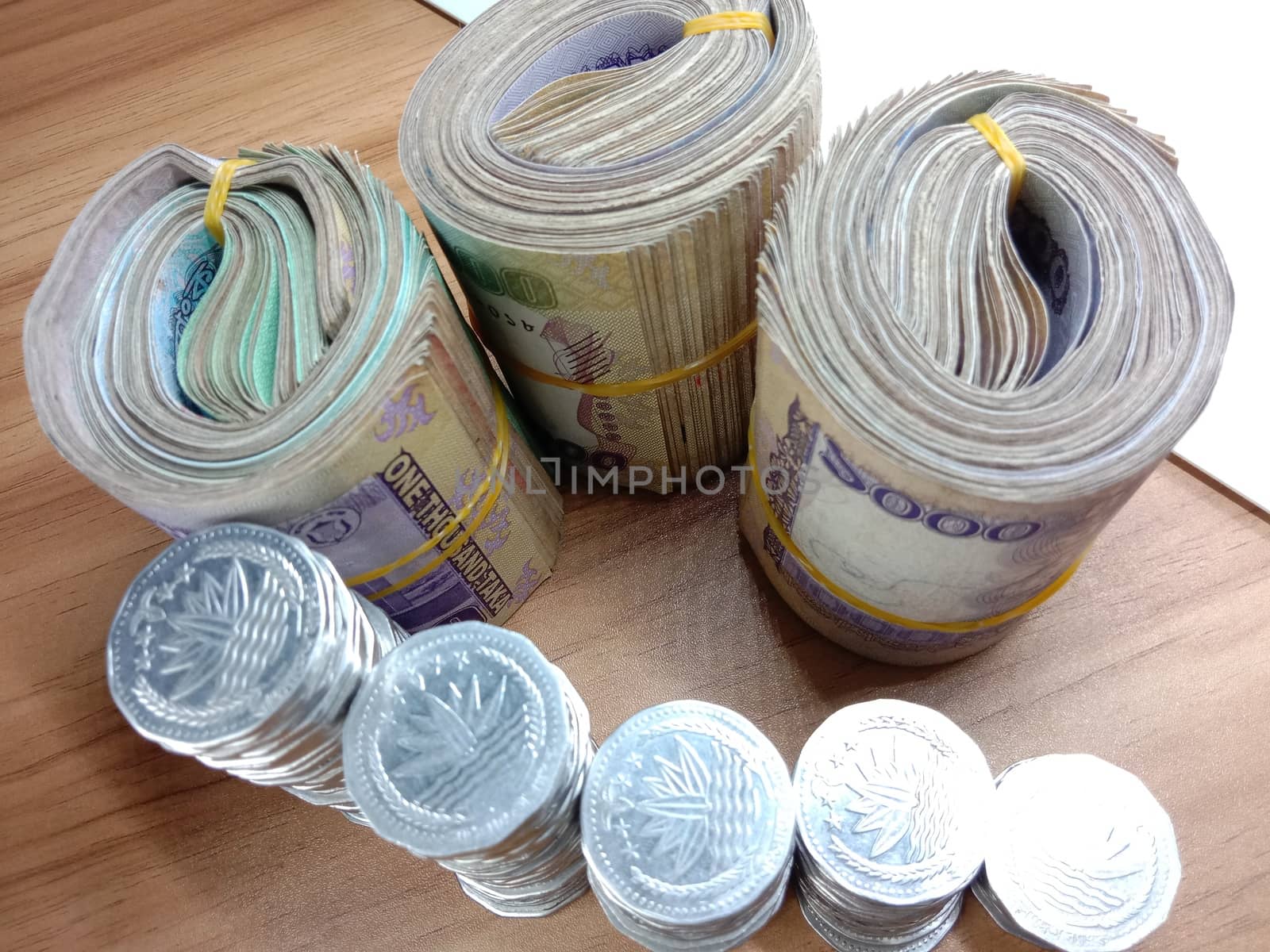 Bangladeshi bank note bundle and coin on white background