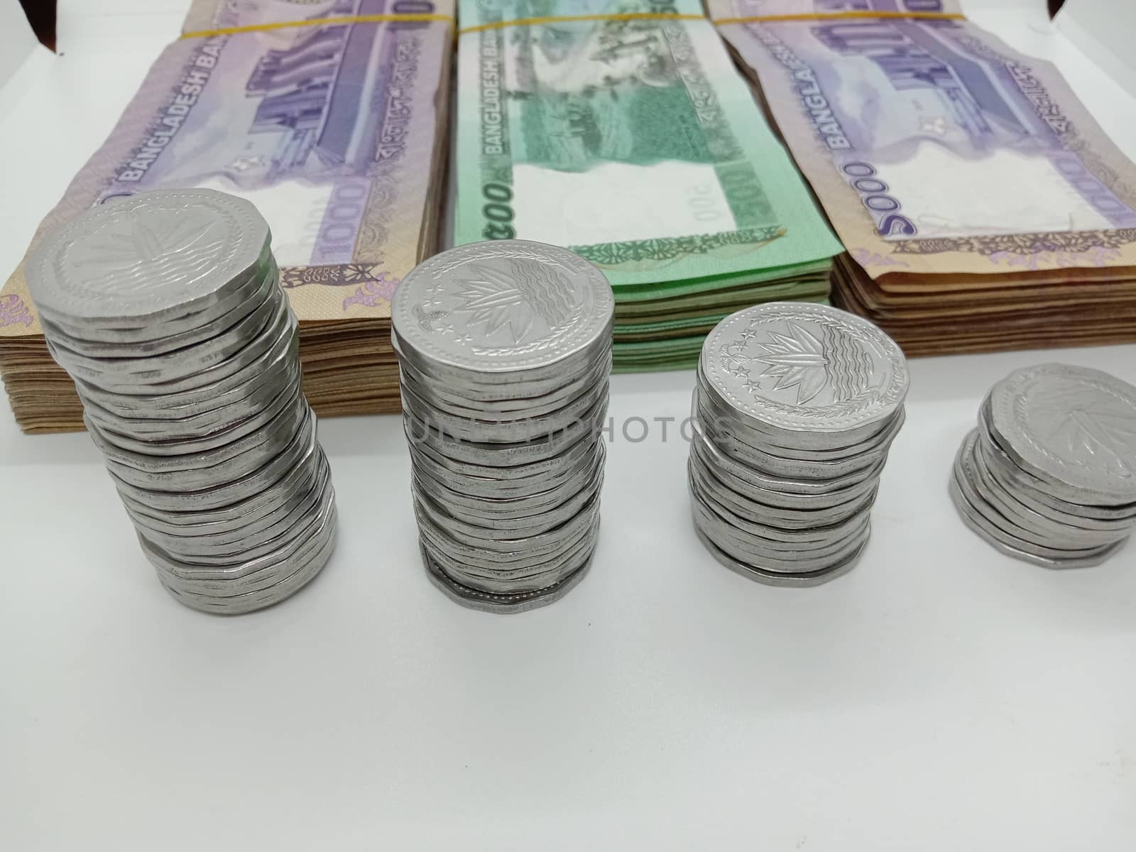 bangladeshi bank note and coin on white background