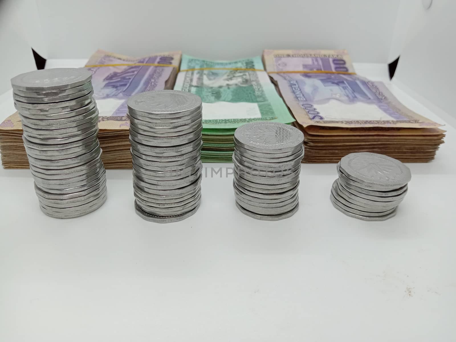 bangladeshi bank note and coin on white background