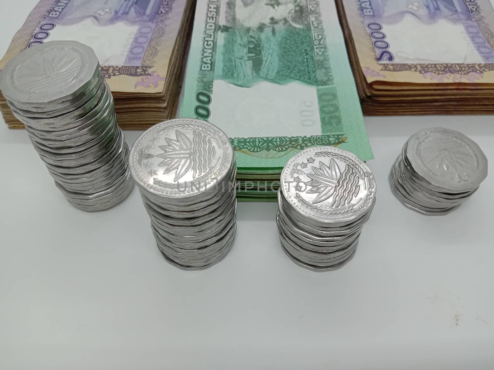 Bangladeshi bank note and coin on white background