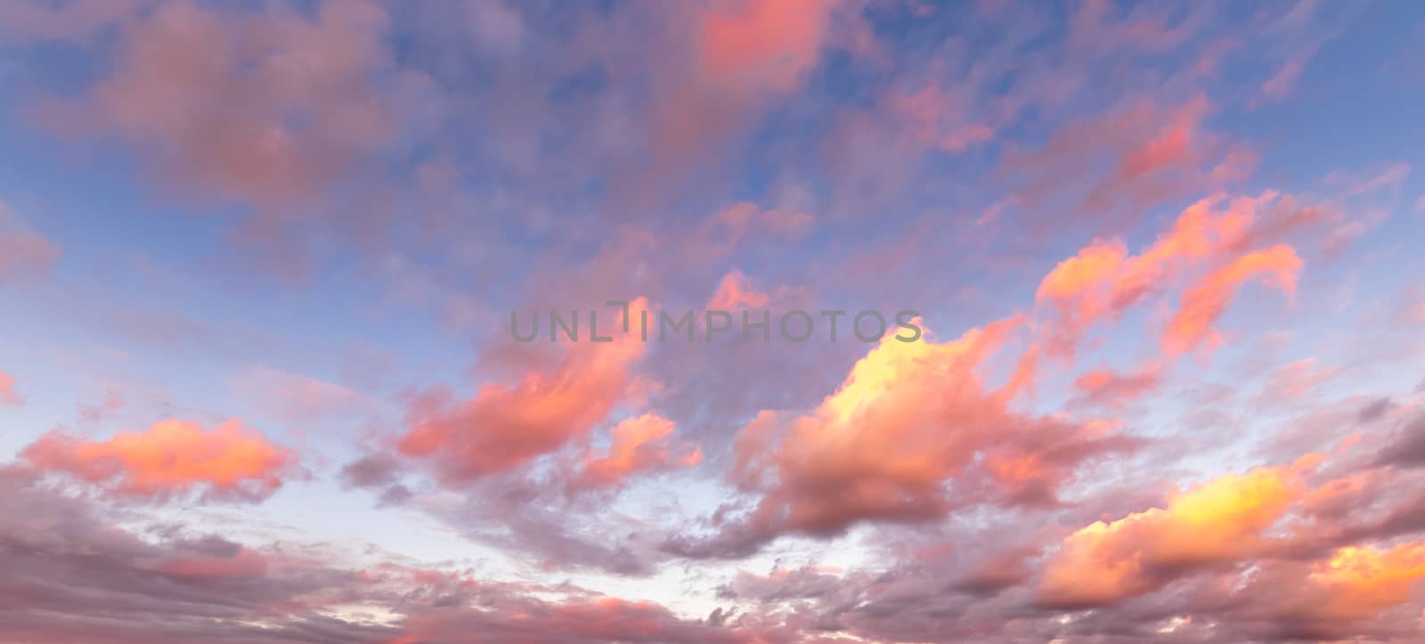 Colorful orange-purple dramatic clouds lit by the setting sun ag by Eugene_Yemelyanov