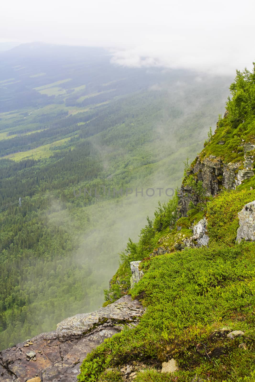 Fog, clouds, rocks and cliffs on Veslehødn Veslehorn mountain in Hemsedal, Norway.