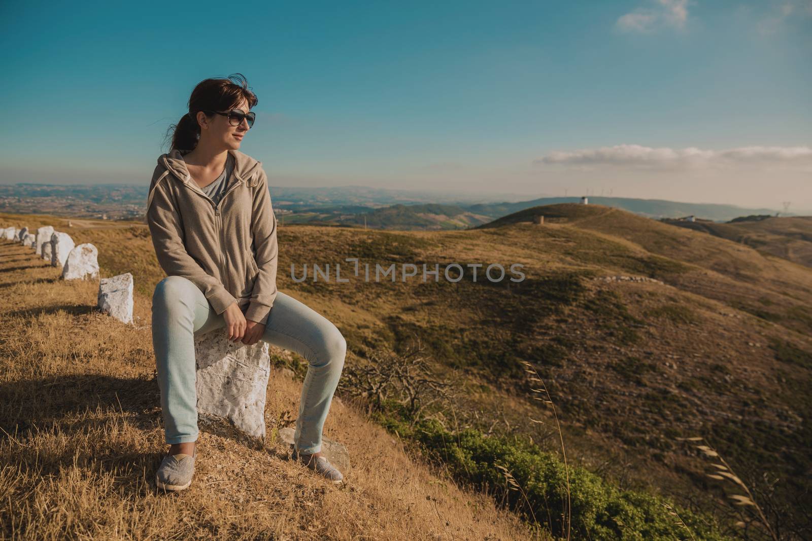 Woman seated looking to the beautitful view
