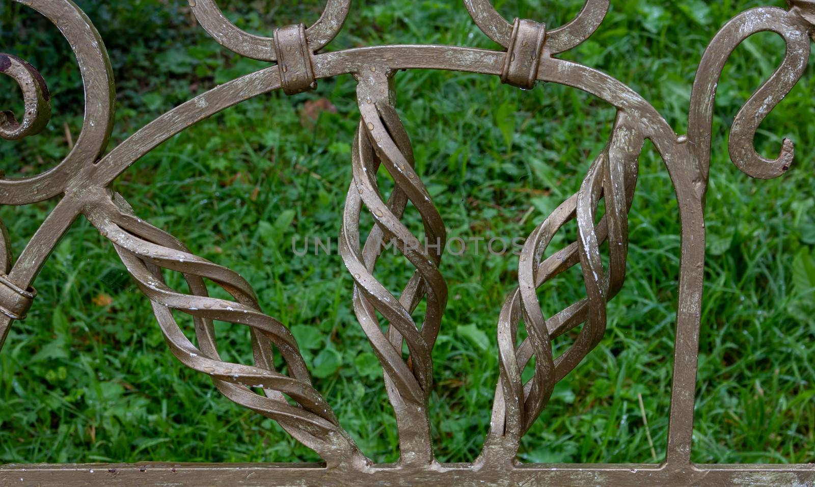 Curlicues on a wrought-iron Park bench. Garden furniture bench.