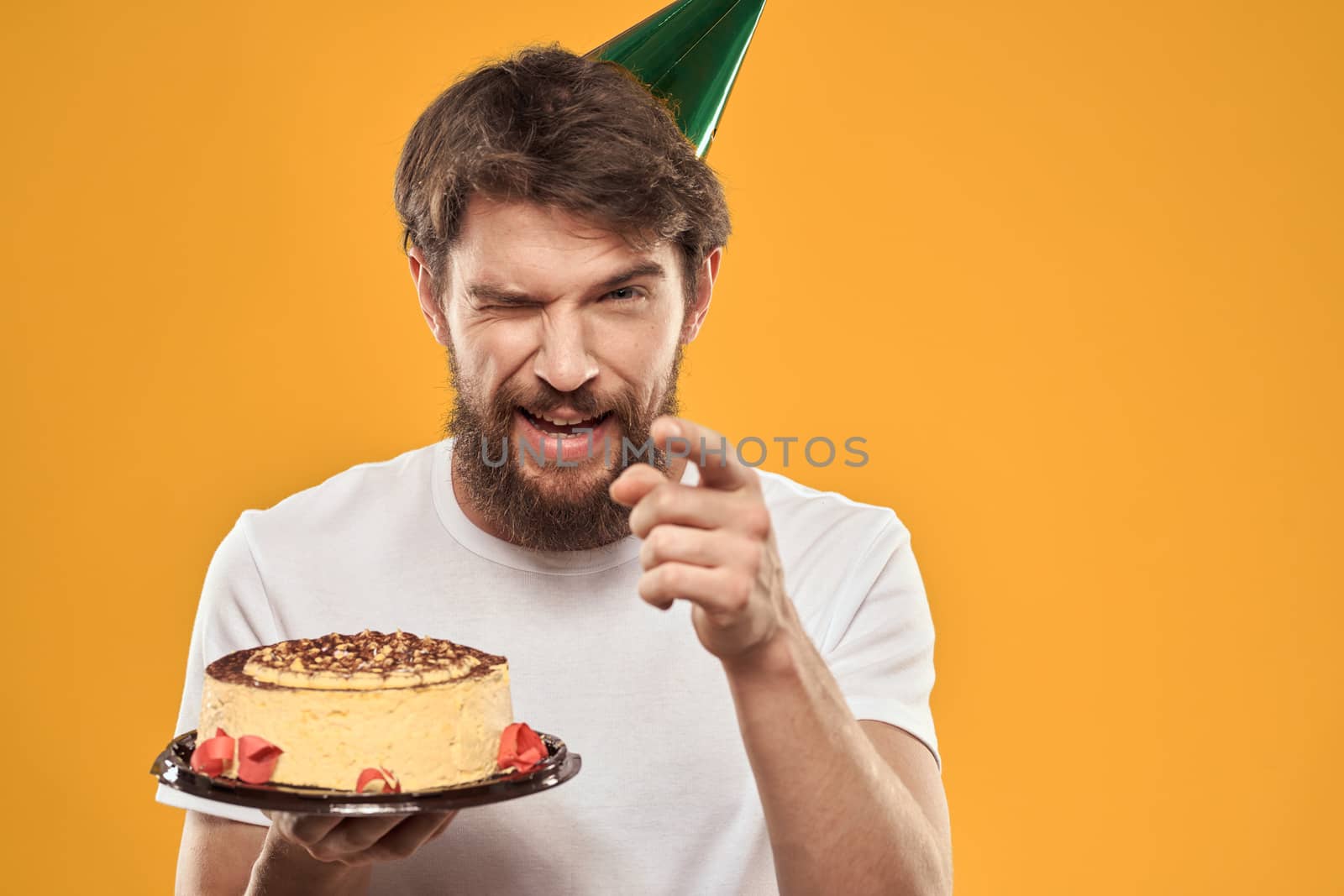 A bearded man with a cake and in a cap celebrating his birthday by SHOTPRIME