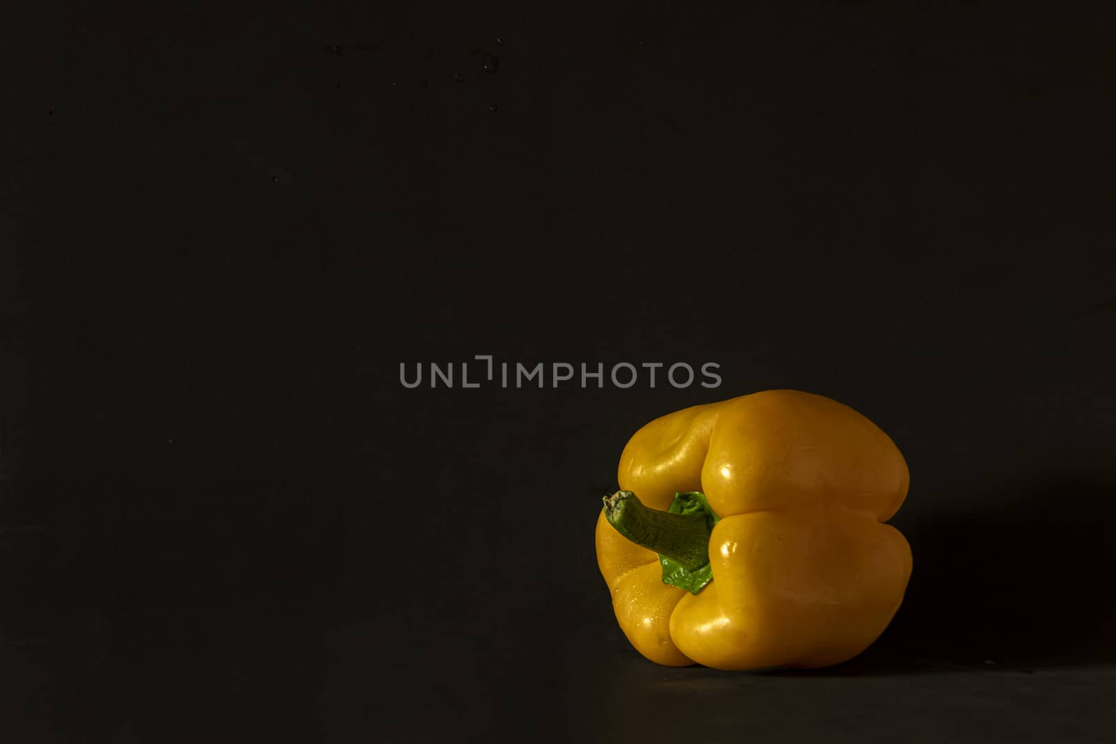 close-up of yellow pepper on a dark background.