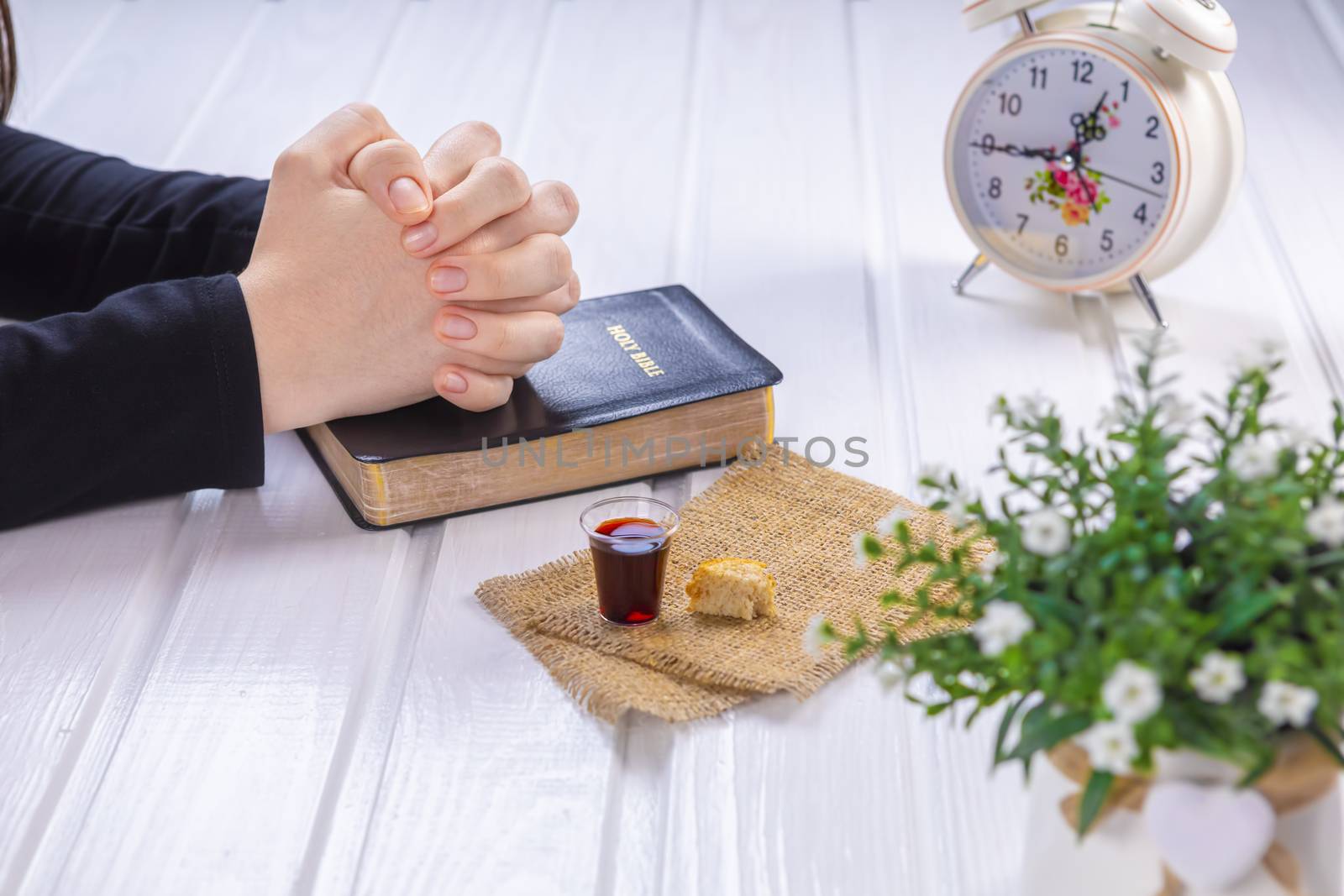 Young woman praying and Taking communion  - the wine and the bre by manaemedia