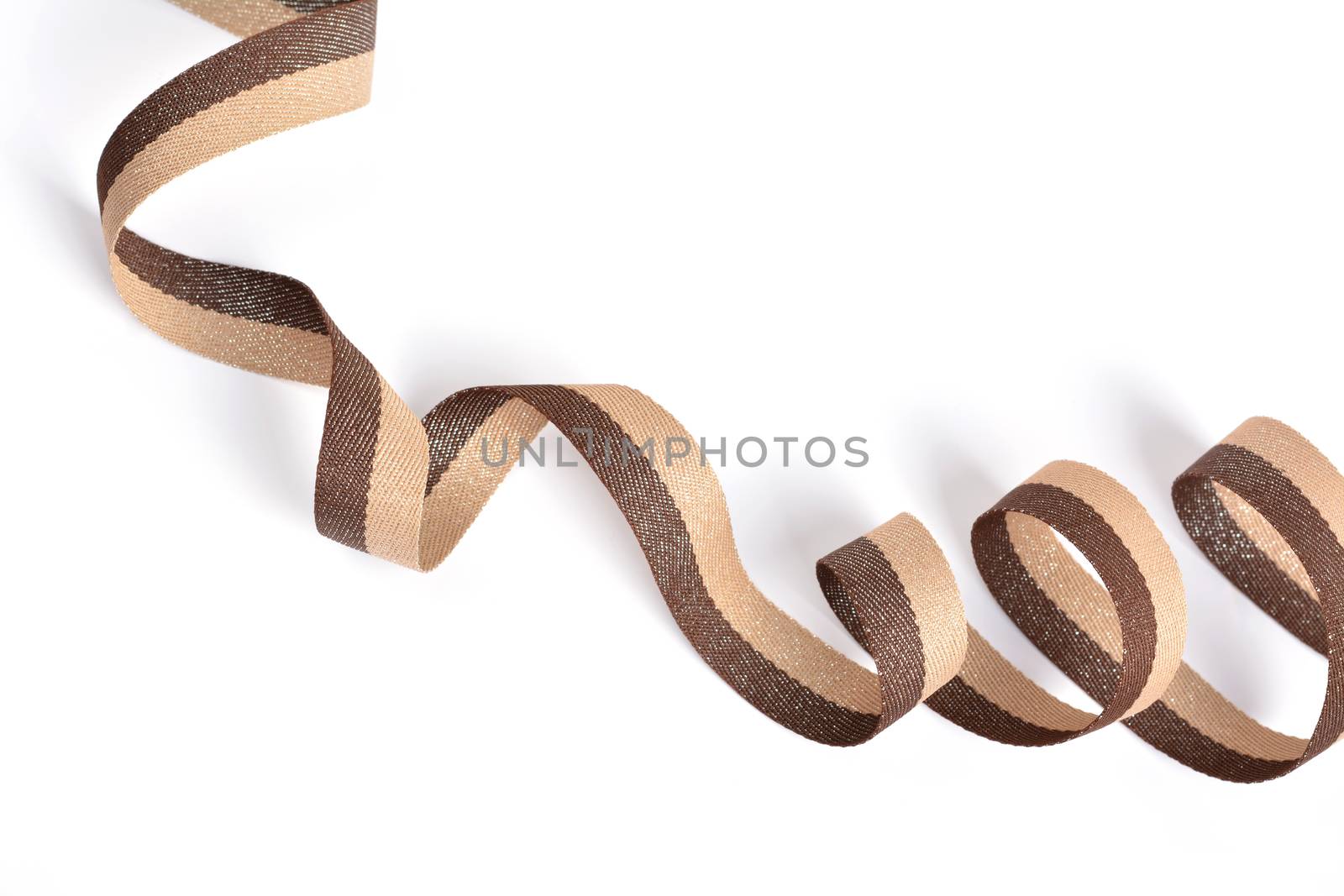 Brown beige Cotton ribbon, roll textilies on bobbin. strapping tape with curl on white backgroud. Use for sewing clothes, bags. Space for text.