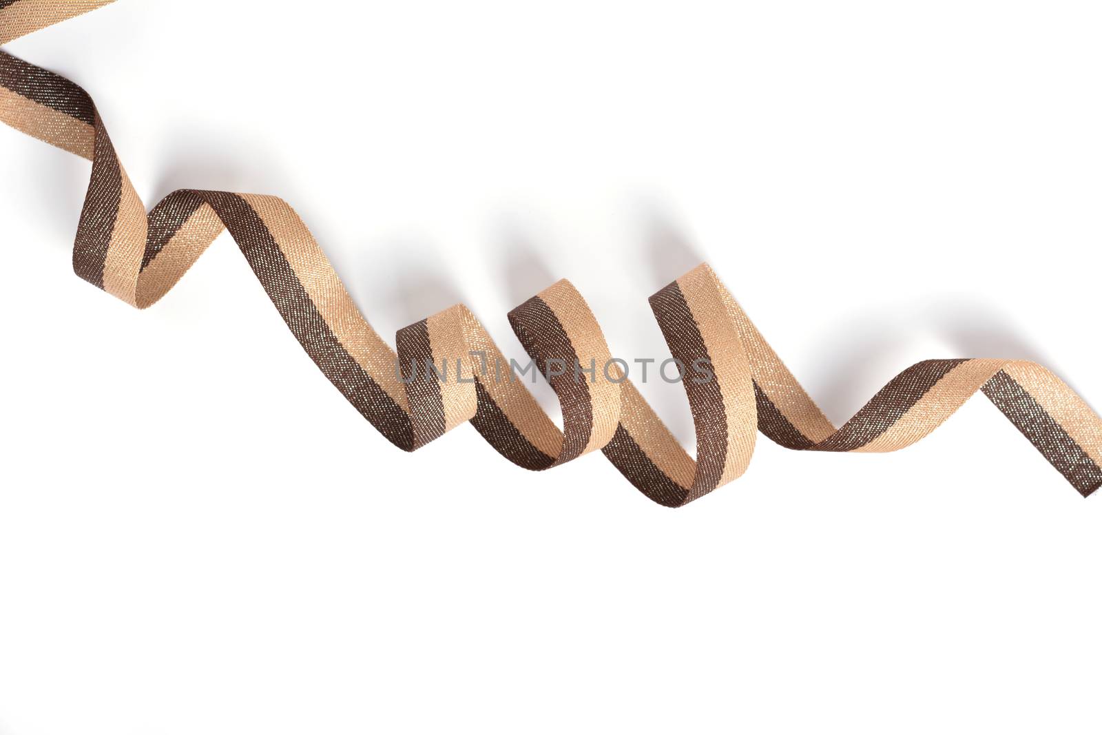 Brown beige Cotton ribbon, roll textilies on bobbin. strapping tape with curl on white backgroud. Use for sewing clothes, bags. Space for text.