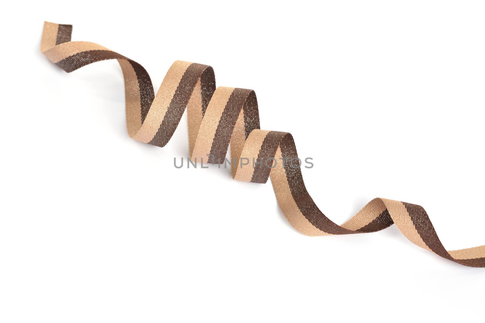 Brown beige Cotton ribbon, roll textilies on bobbin. strapping tape with curl on white backgroud. Use for sewing clothes, bags. Space for text.