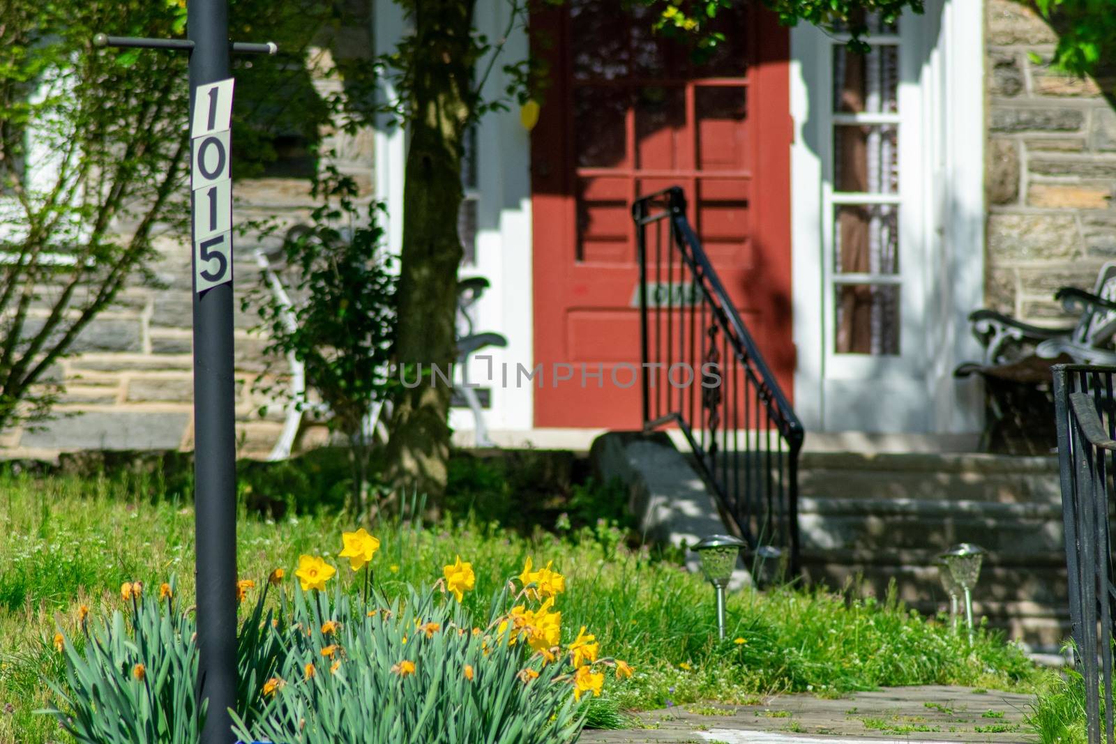 A Post With an Address Number In a Suburban Front Yard by bju12290