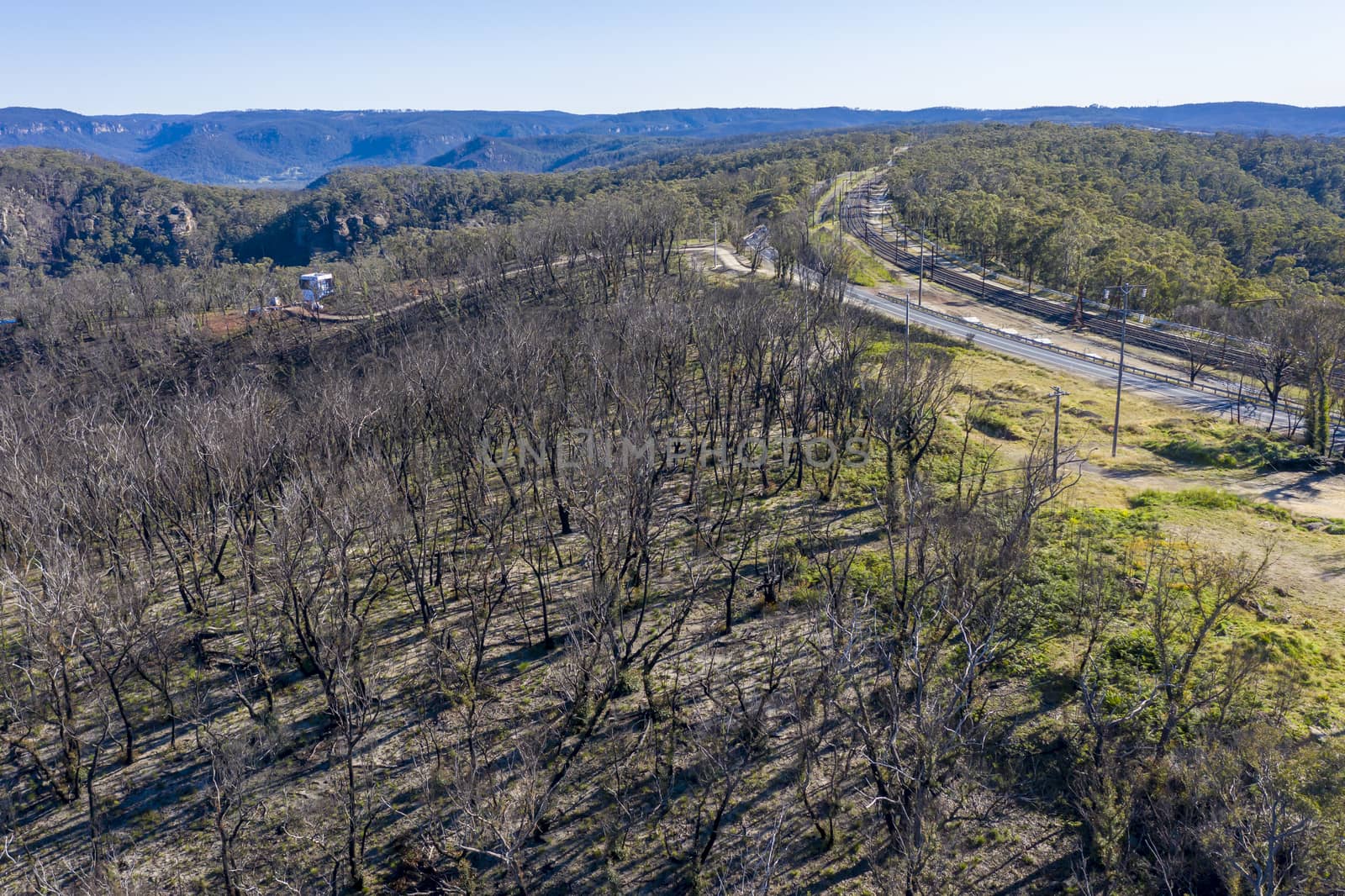 Aerial view of the Great Western Highway running through forest burnt by bushfires at Mount Victoria in The Blue Mountains in New South Wales in Australia