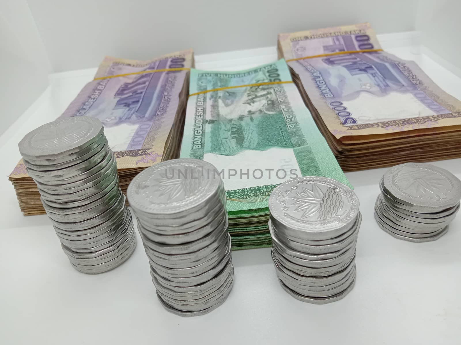 Bangladeshi bank note bundle and coin on white background