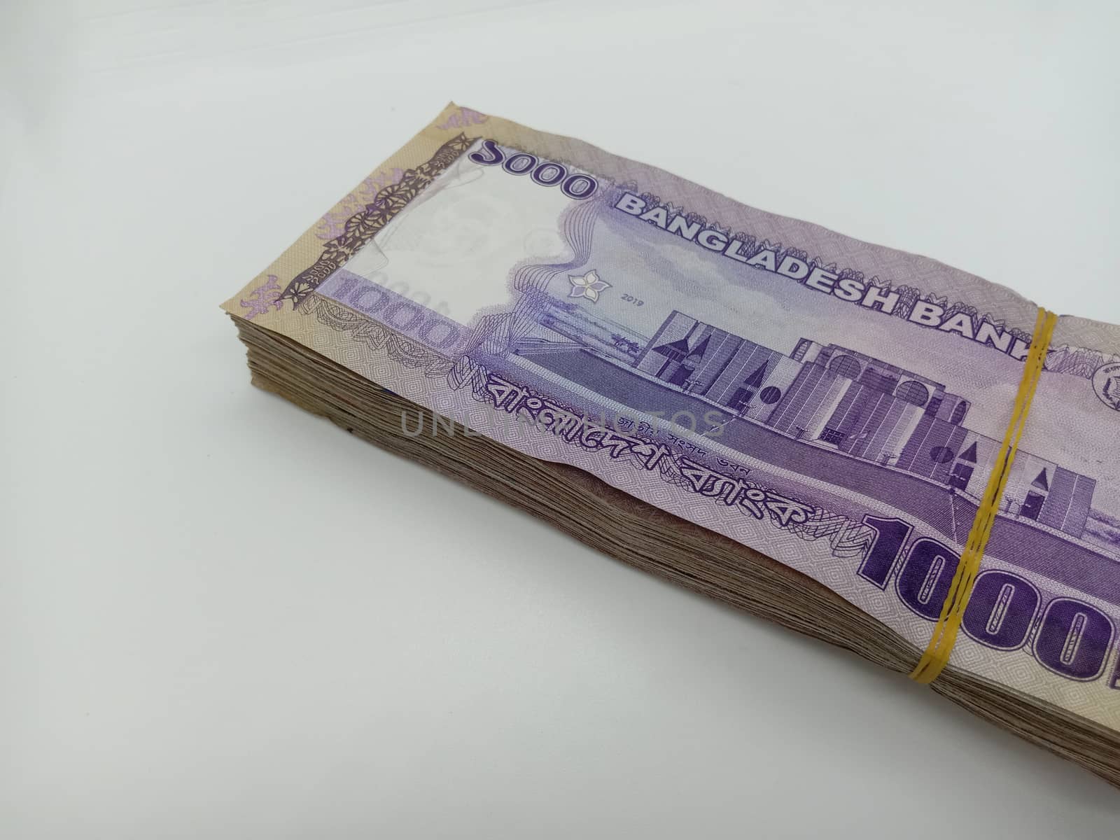 Bangladeshi bank note bundle on white background