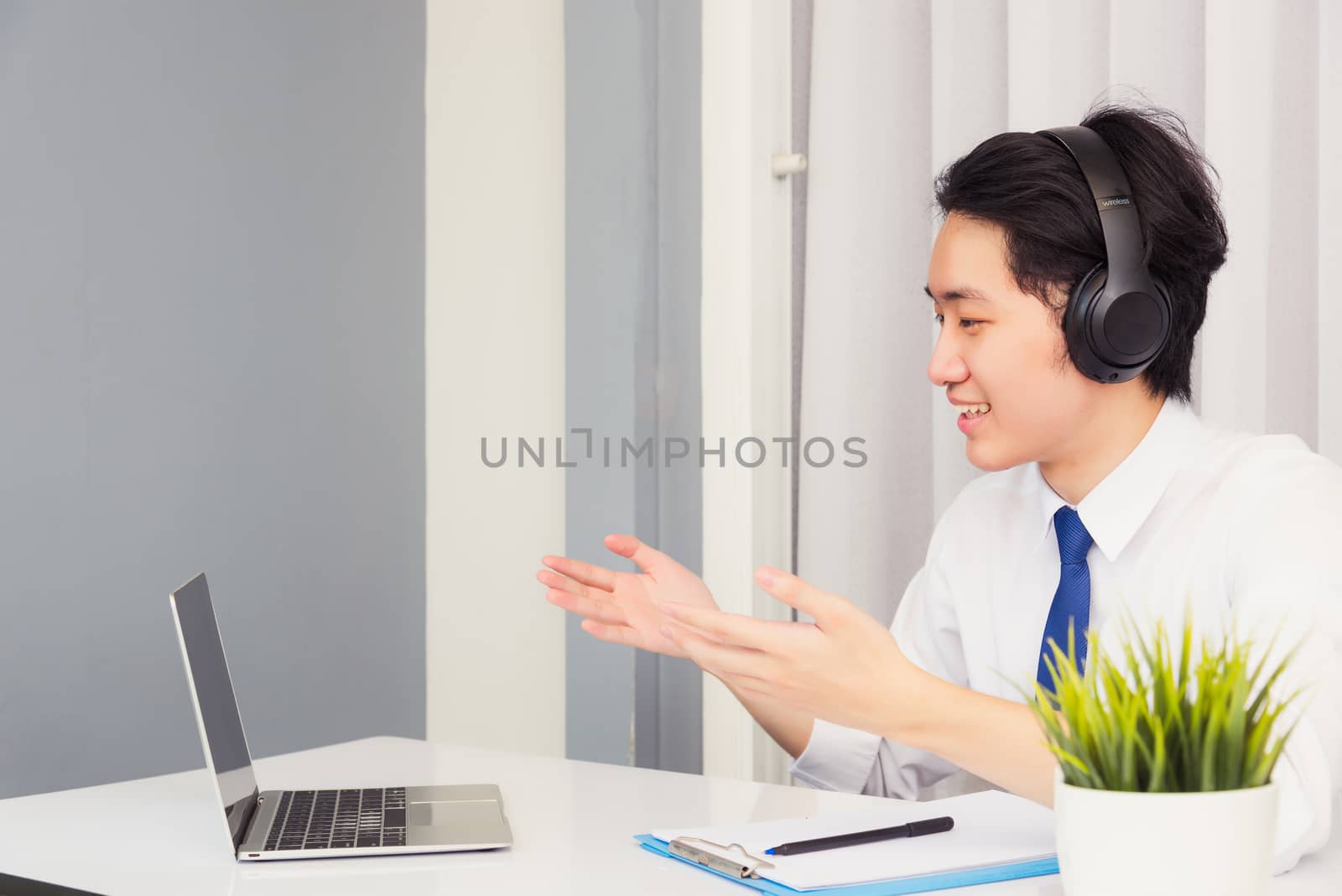 Asian young businessman smile wearing headphones and suit video  by Sorapop