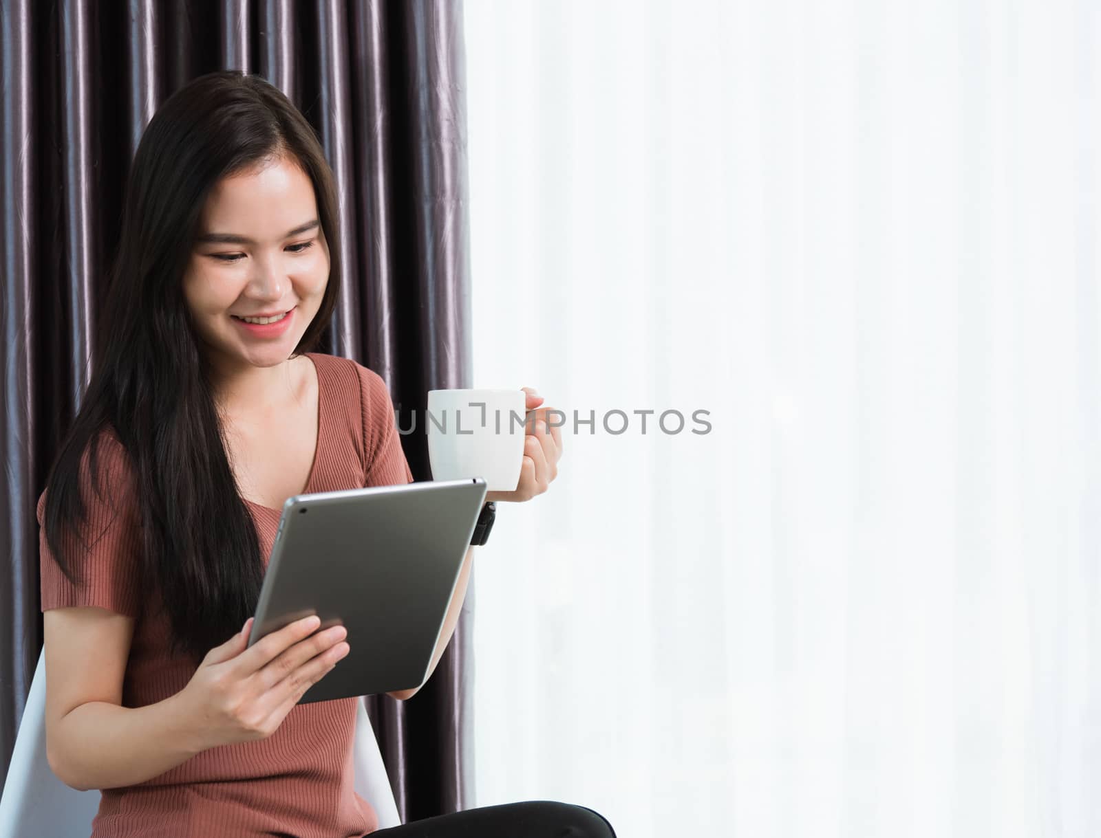 Work from home, Happy Asian young businesswoman smile video conference call or facetime by modern digital smart tablet computer she uses finger touching on screen, looking to tablet at home office