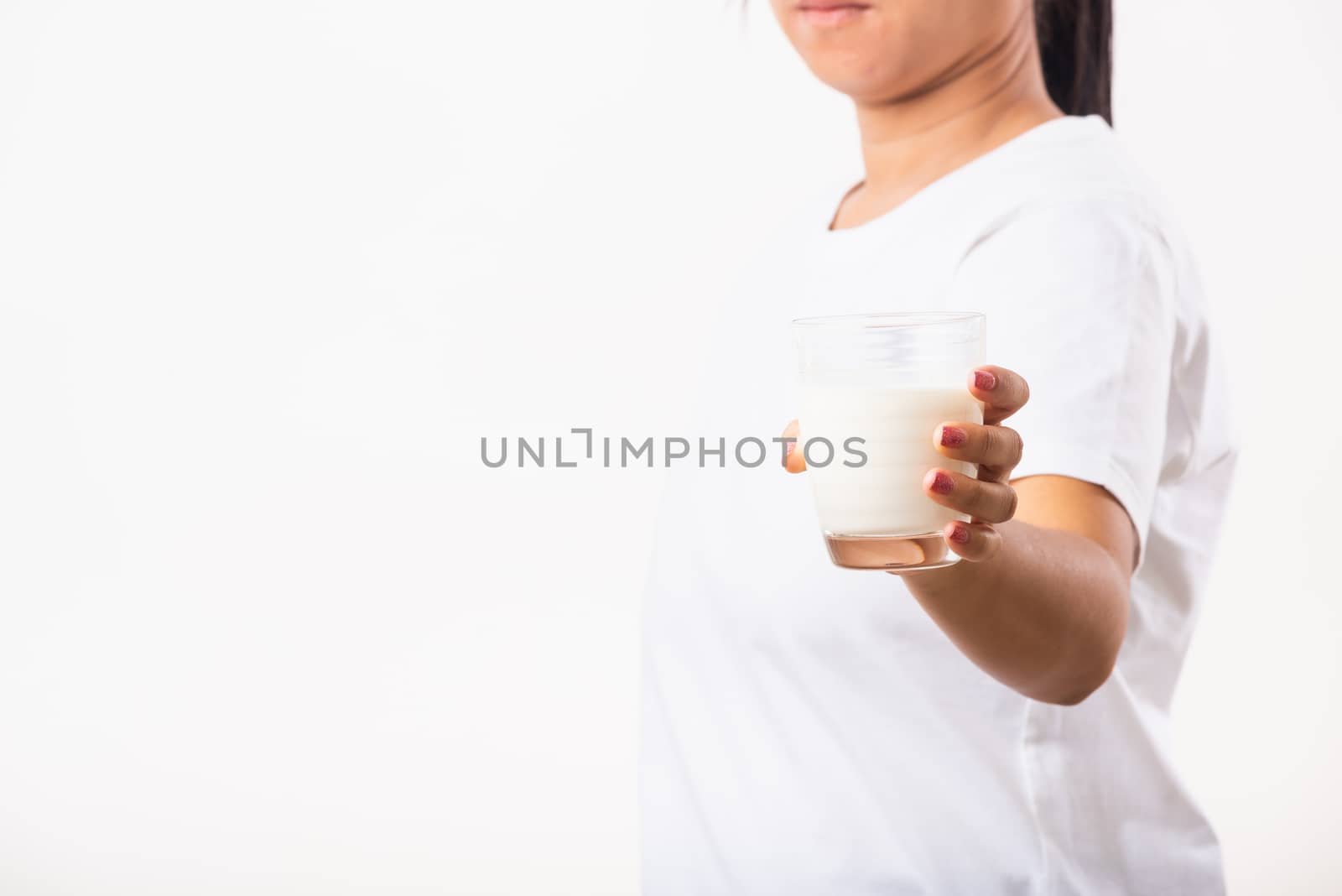 Asian portrait of happy young Asian beauty woman use hands hold drink white milk from a glass, studio shot isolated on white background, Food healthy care concept