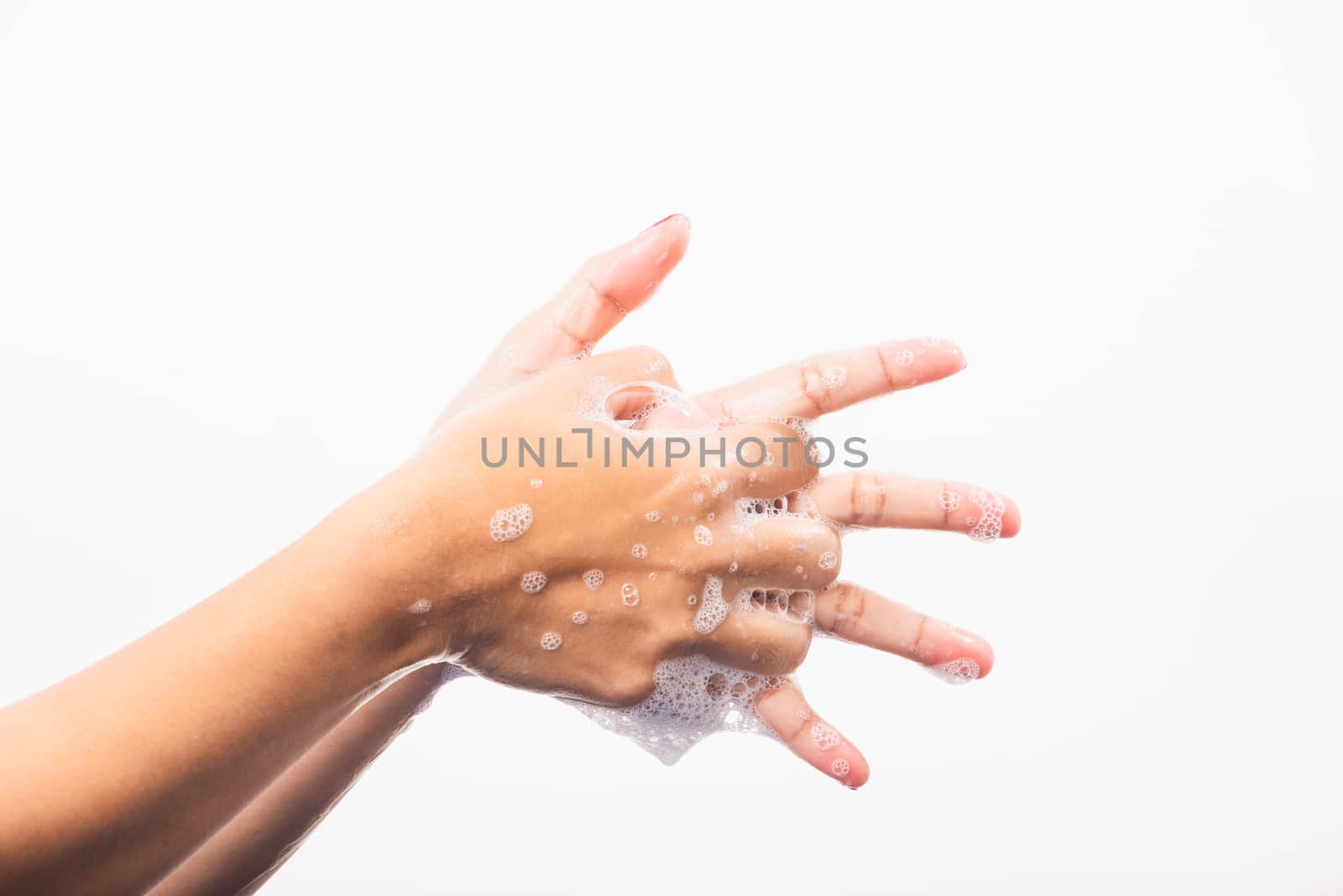 Closeup young Asian woman washing hands by soap for cleanliness and prevent germs coronavirus, studio shot isolated on white background, Healthcare medical COVID-19 virus concept