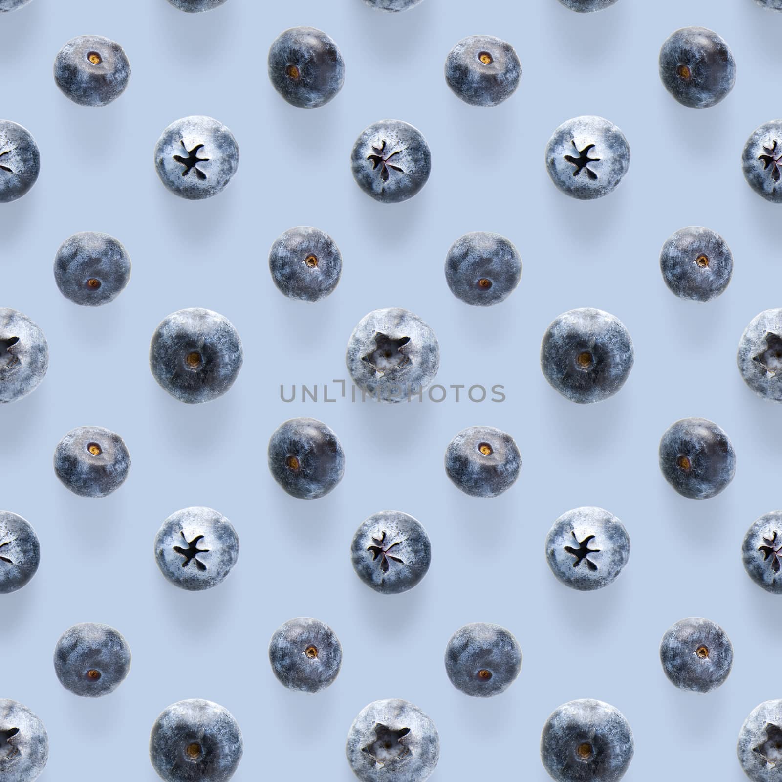 Trendy seamless pattern of blueberries. Blueberry pattern isolated on blue background. Blueberry flat lay, can be used for textile, prints, packing designs orother moden andcreative works