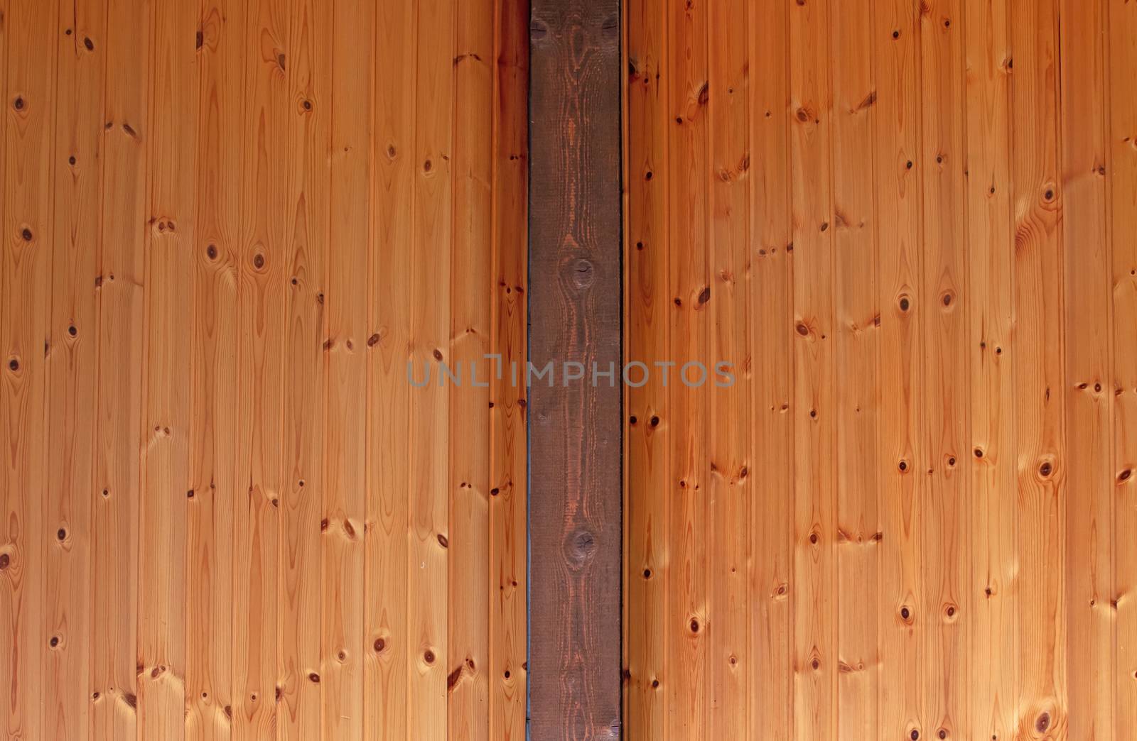 Rustic house ceiling with wide wooden beam support, pine wood