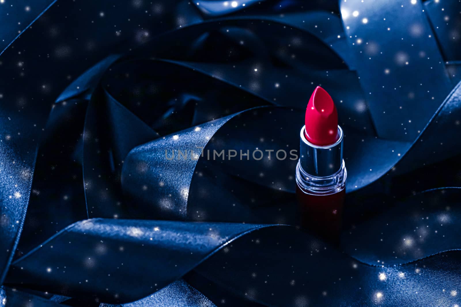 Red lipstick on blue silk and shiny glitter background, luxury make-up and beauty cosmetics