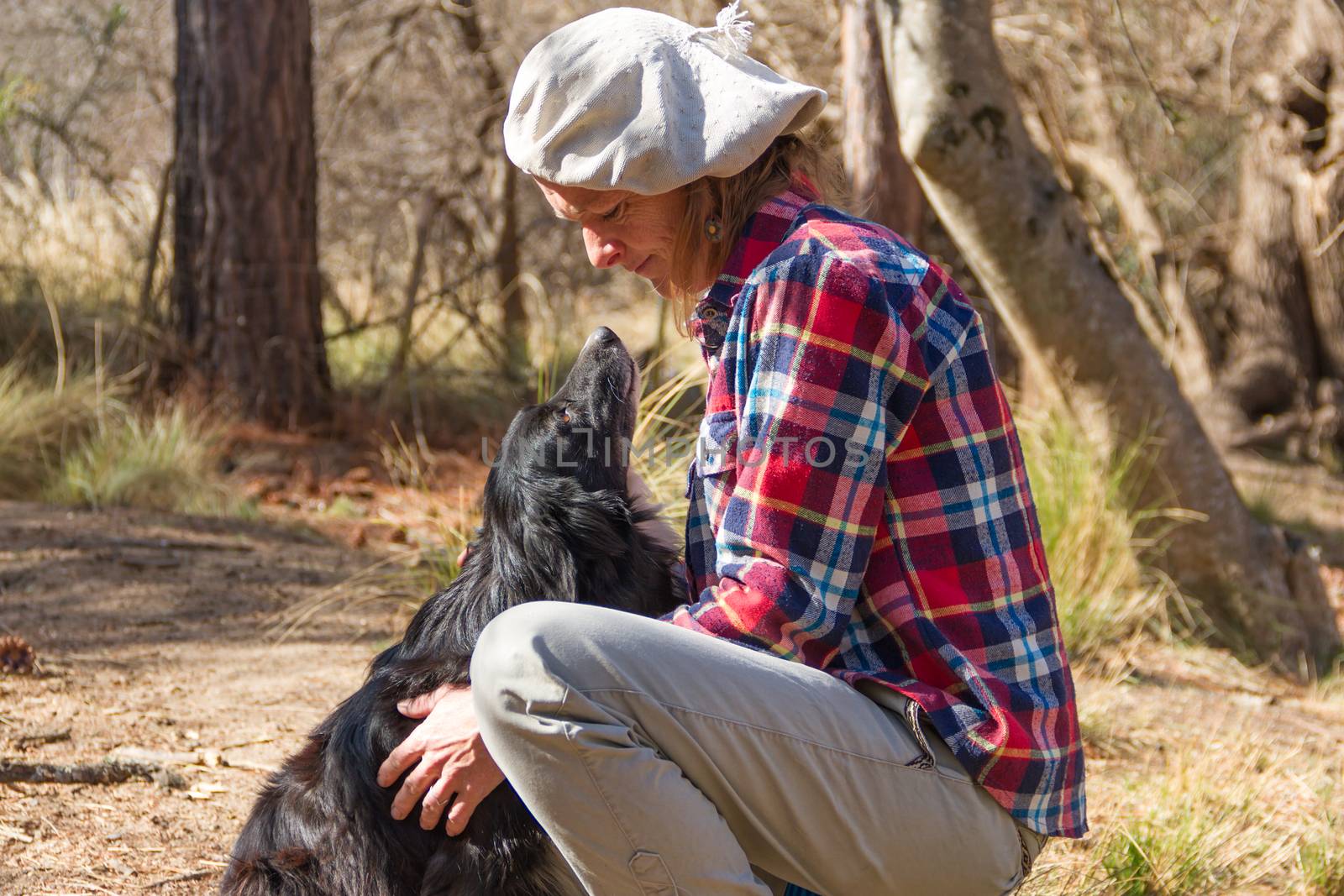 portrait of a woman farm worker with her dog by GabrielaBertolini