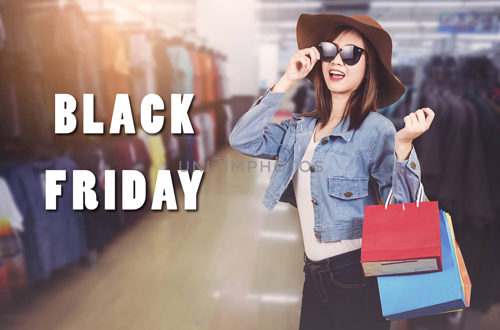 Happy portrait beautiful young woman teen smiling standing with sunglasses and hat she excited holding shopping bags multi color on the mall with copy space, Black Friday sale concept