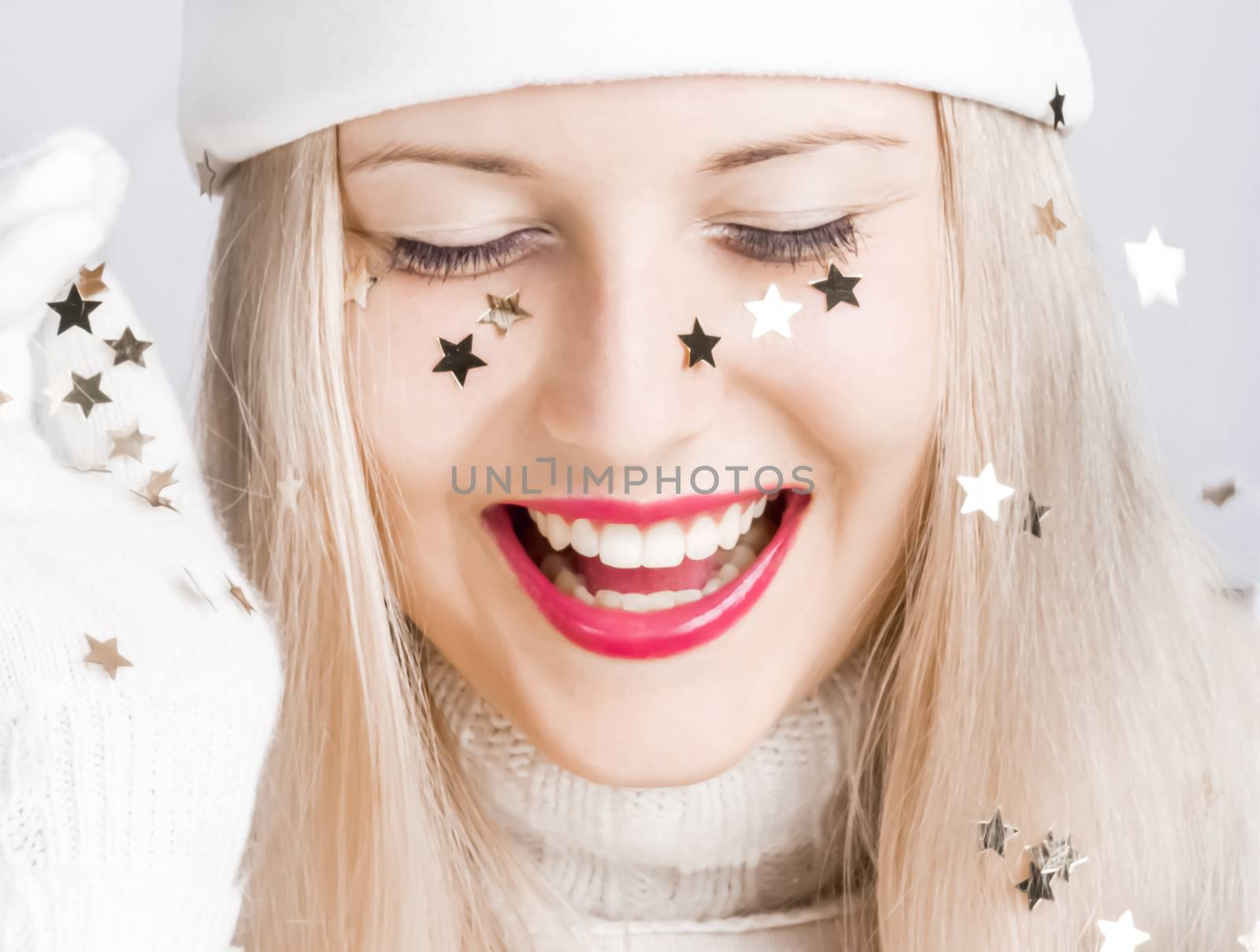 Young woman celebrating Christmas time, happy smile by Anneleven