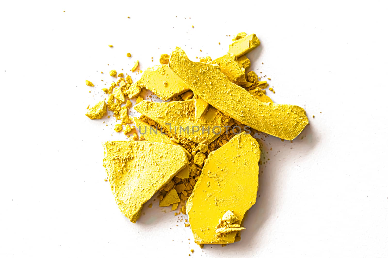 Yellow eye shadow powder as makeup palette closeup isolated on white background, crushed cosmetics and beauty texture by Anneleven