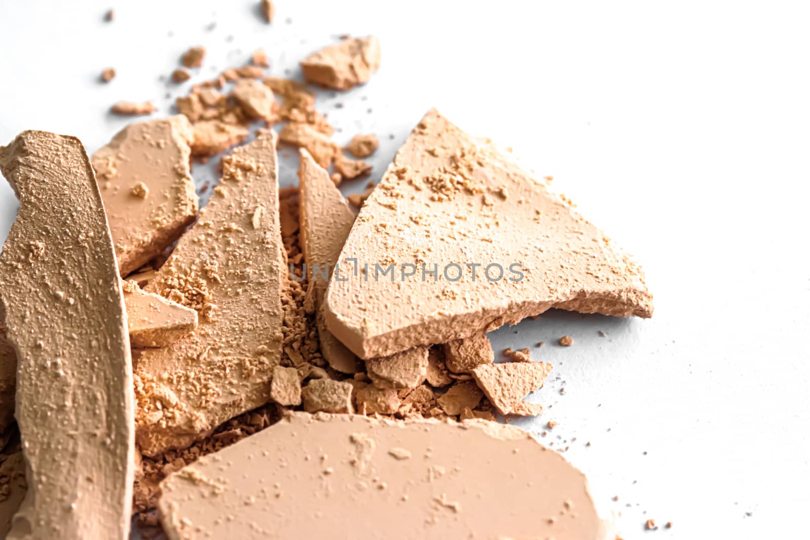 Beige eye shadow powder as makeup palette closeup isolated on white background, crushed cosmetics and beauty textures