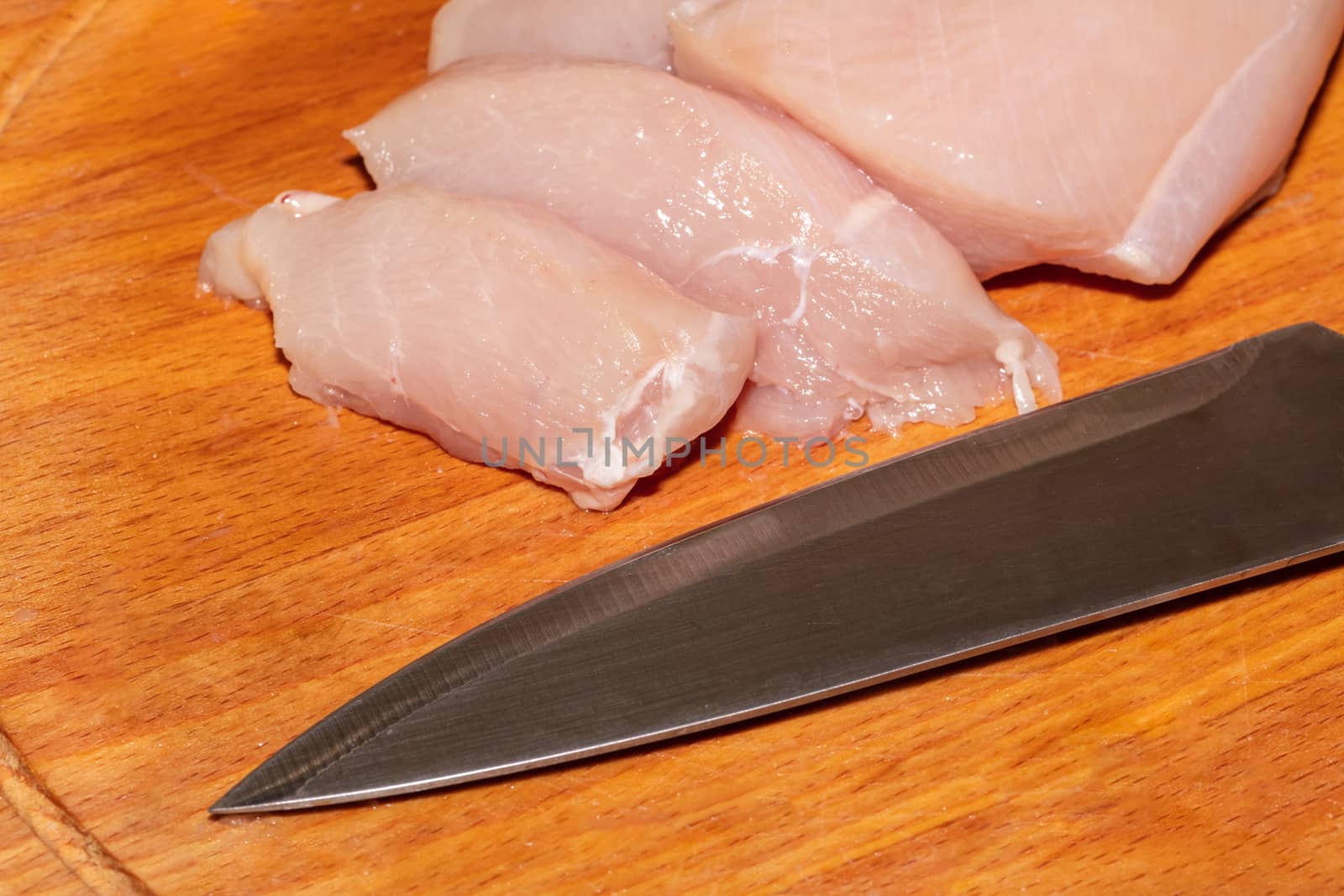 High angle close-up shot of chicken pieces, knife by DamantisZ