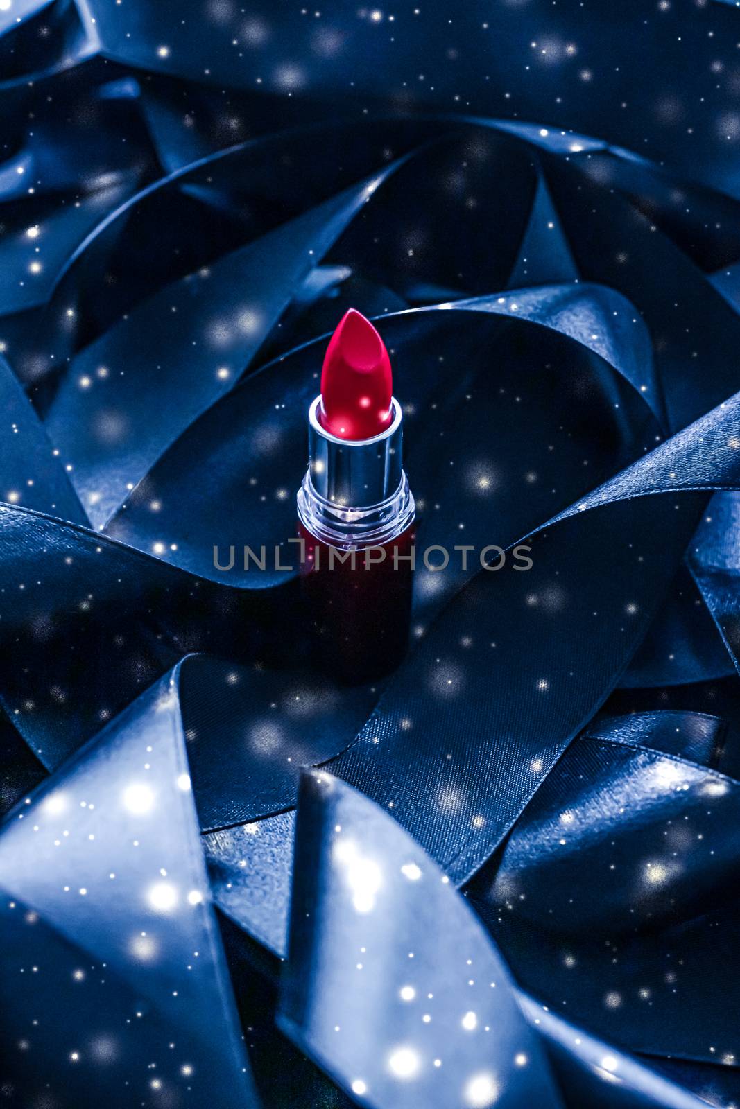 Red lipstick on blue silk and shiny glitter background, luxury make-up and beauty cosmetics