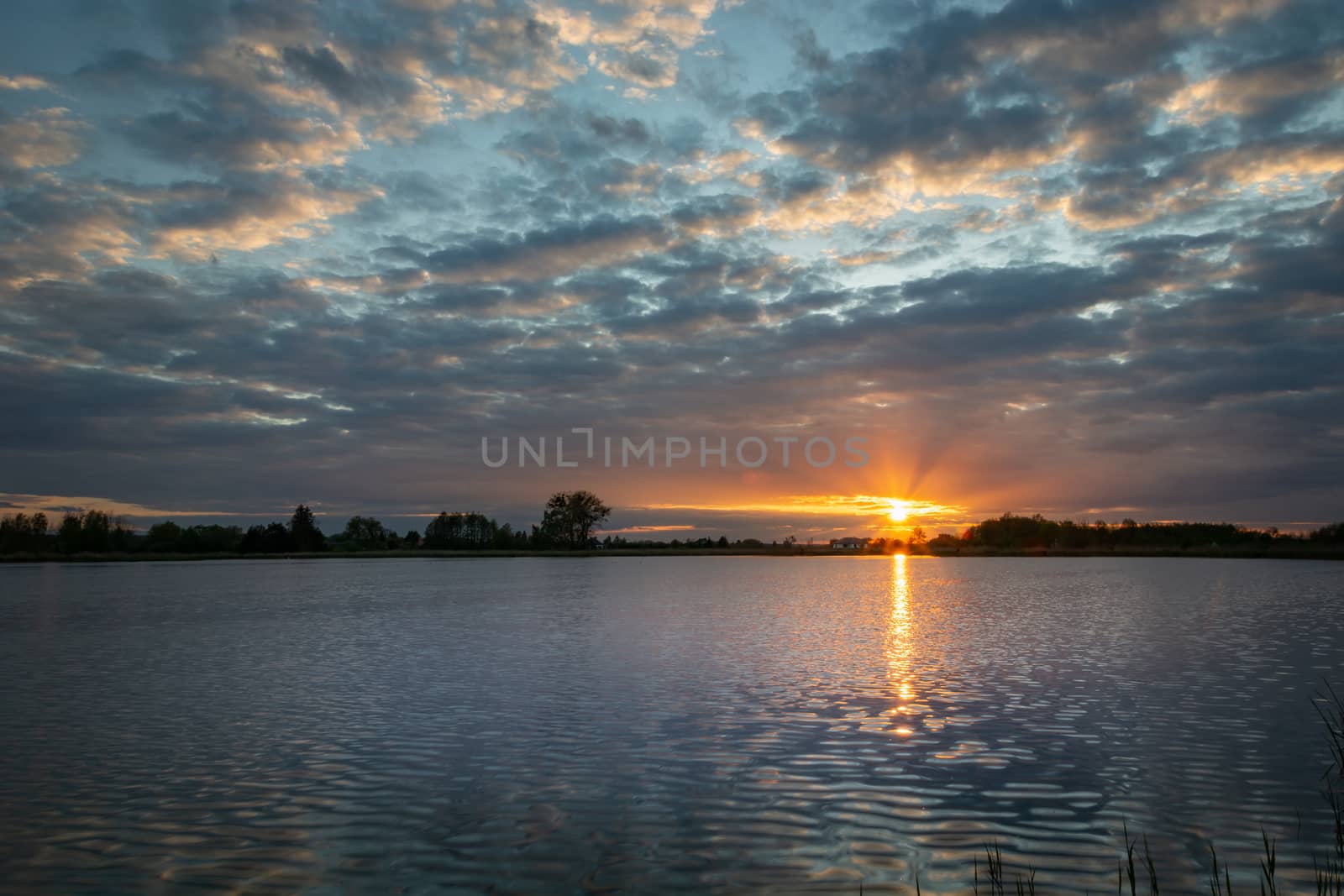 Beautiful sunset with clouds over the lake by darekb22