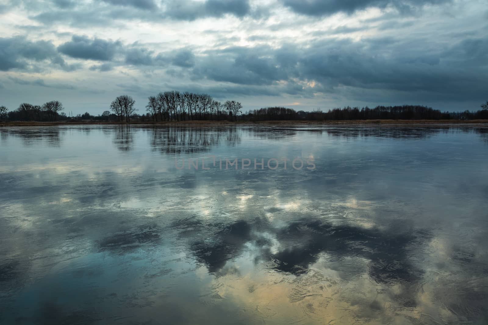 The reflection of clouds in the ice on the lake, winter view