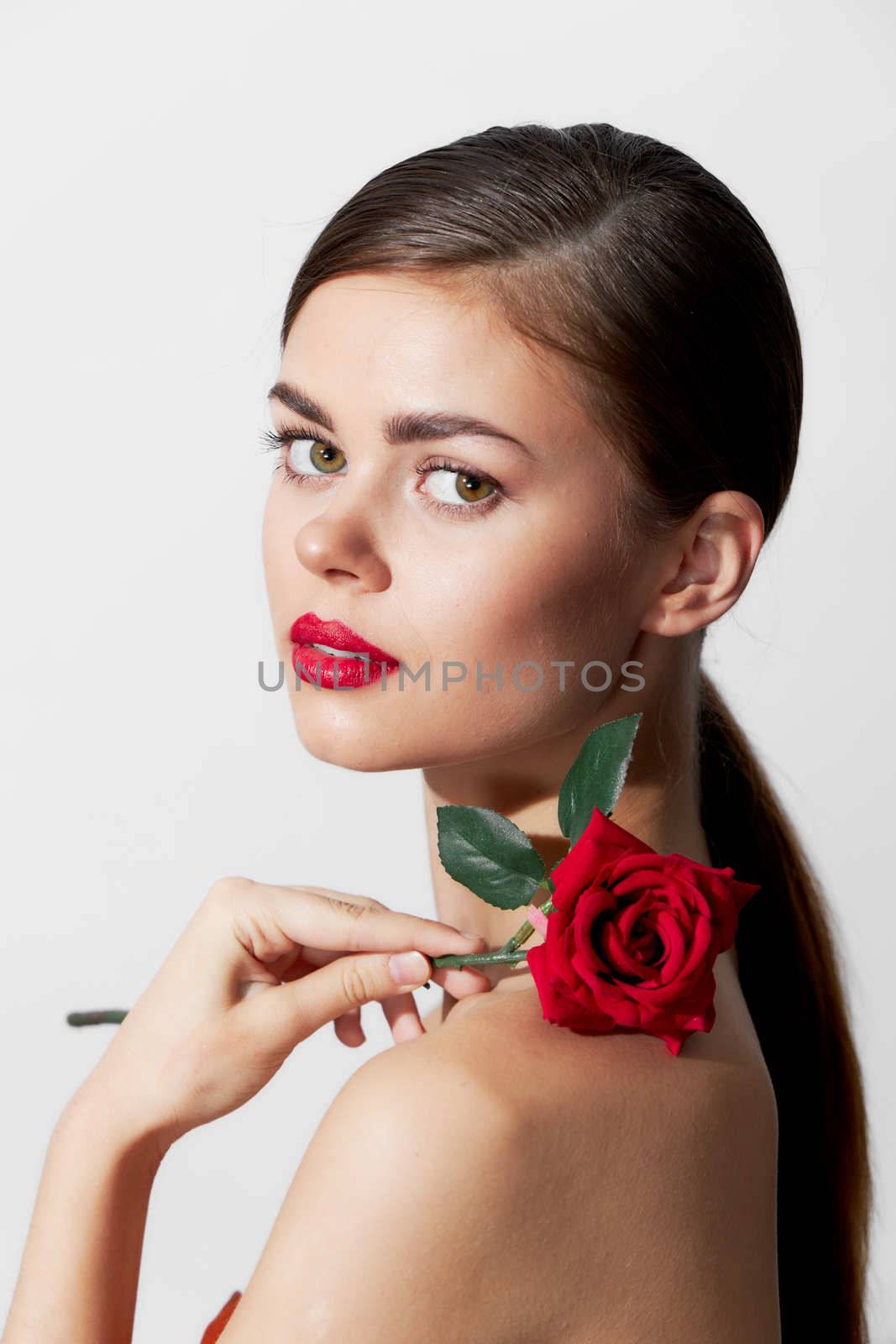 Woman with bare shoulders Red lips pure luxury skin makeup background