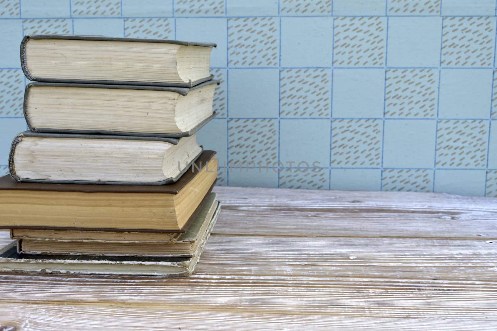 old books stacked on wooden table, retro interior