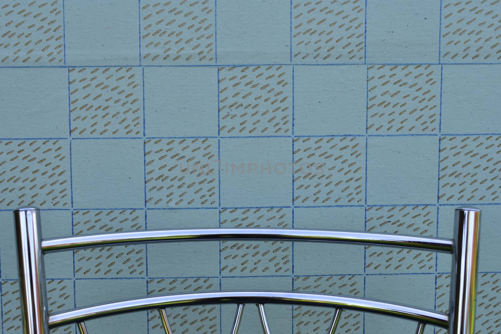 wall with vintage wallpaper, backrest of modern metal chair, background