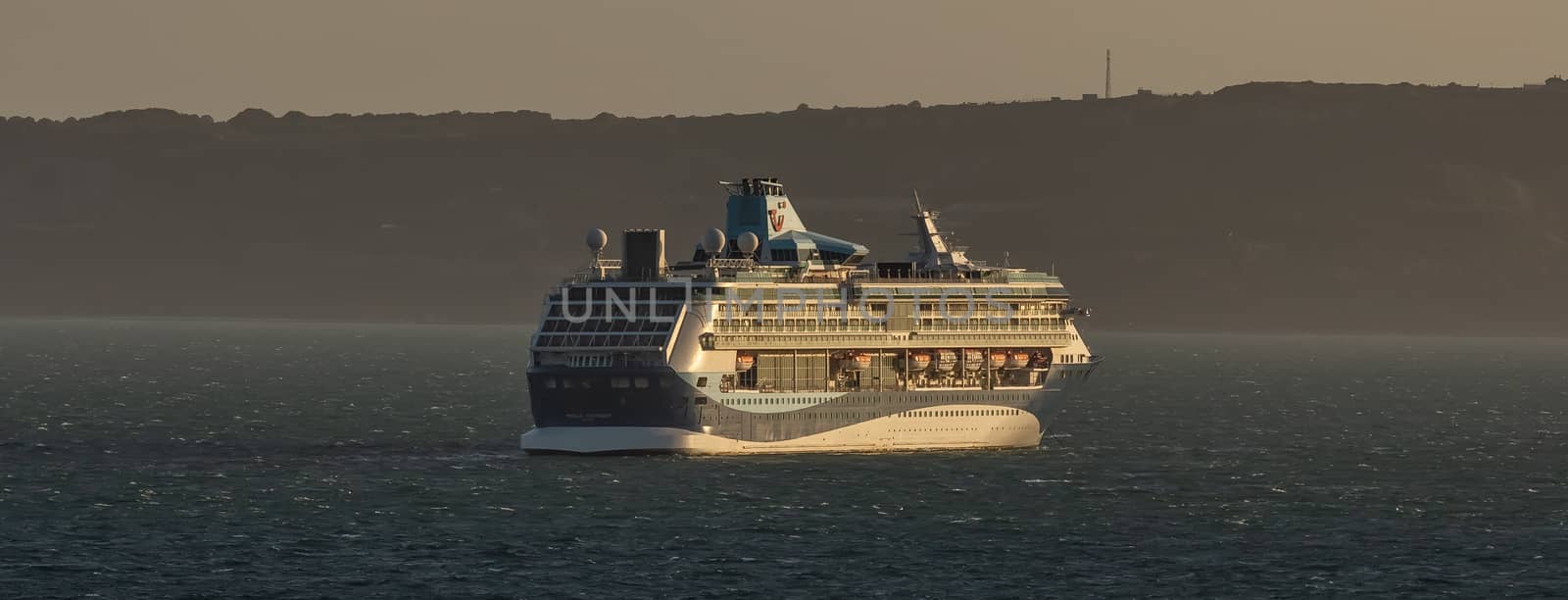 Weymouth Bay, United Kingdom - July 5, 2020: Beautiful shot of cruise ship Marella Discovery anchored in Weymouth Bay at sunset.