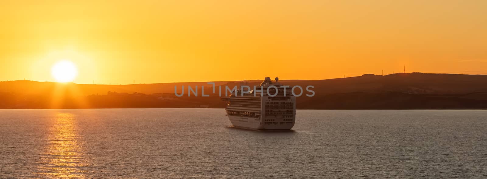 Weymouth Bay, United Kingdom - July 6, 2020: Beautiful panoramic shot of P&O cruise ship Ventura anchored in Weymouth Bay at sunset