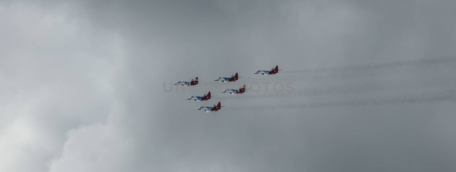 Barnaul, Russia - September 18, 2020: A low angle shot of Strizhi MiG-29 fighter jet squadron performing stunts during an aeroshow.