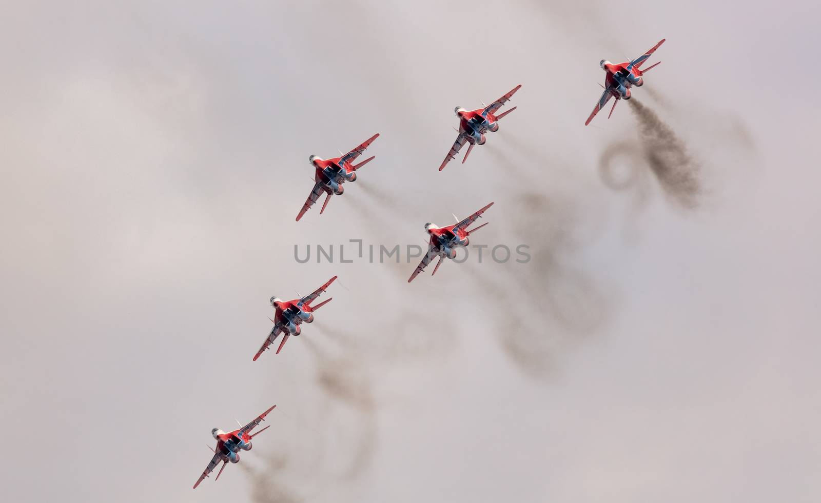 Barnaul, Russia - September 19, 2020: A low angle shot of Strizhi MiG-29 fighter jet squadron performing stunts during an aeroshow.