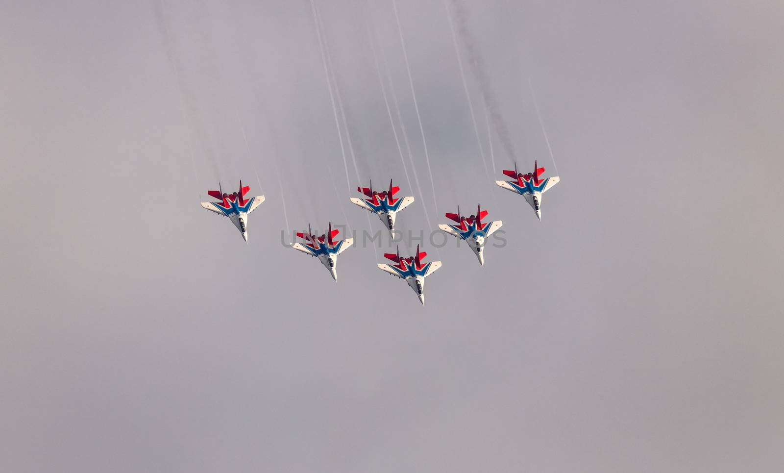 Barnaul, Russia - September 19, 2020: A high angle shot of Strizhi MiG-29 fighter jet squadron performing stunts during an aeroshow.