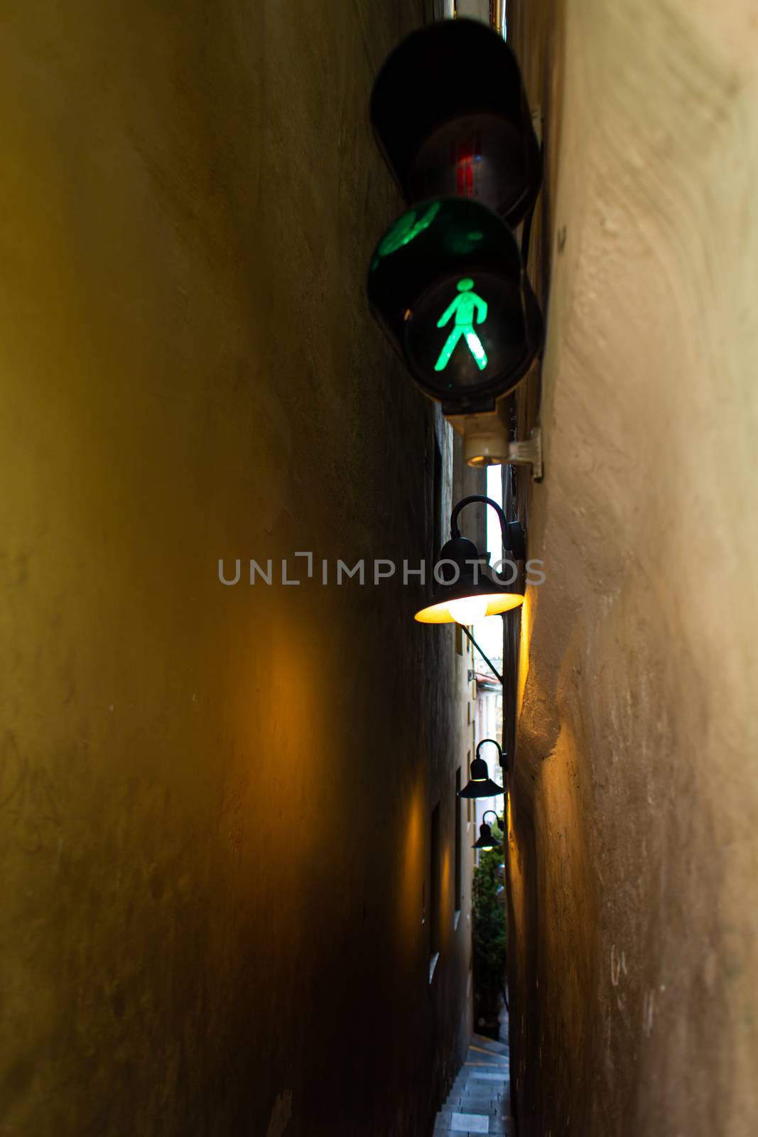 The architecture of the strago city of Prague. The narrowest street in Europe. The passage between buildings for one person, regulated by traffic lights.