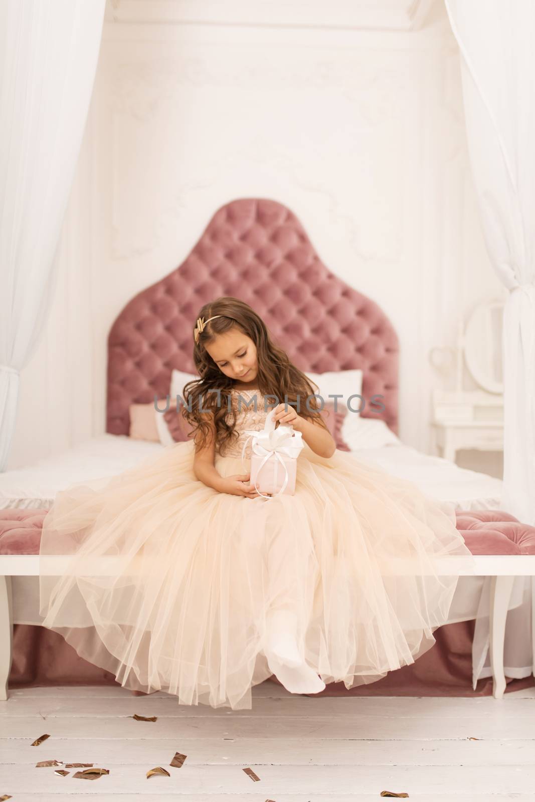 Happy childhood, magical Christmas tale. Little princess with Santa's present for Christmas.