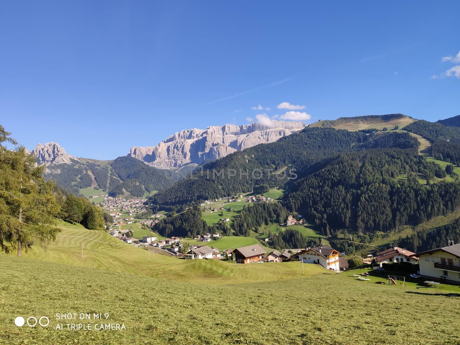 Val Gardena, Italy - 09/15/2020: Scenic alpine place with magical Dolomites mountains in background, amazing clouds and blue sky  in Trentino Alto Adige region, Italy, Europe