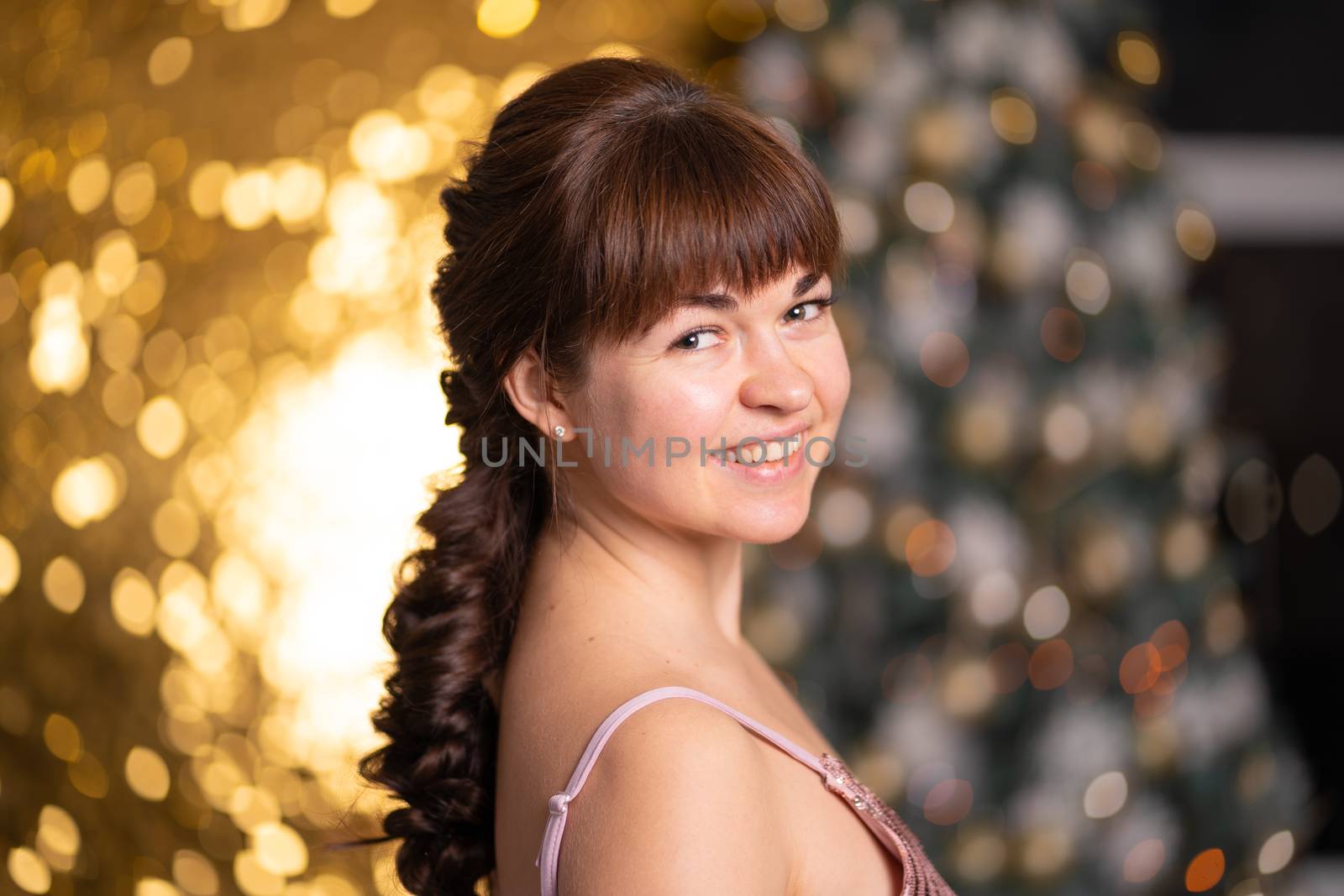 Stylish beautiful girl among sparkles and gerlands at a Christmas party by Try_my_best