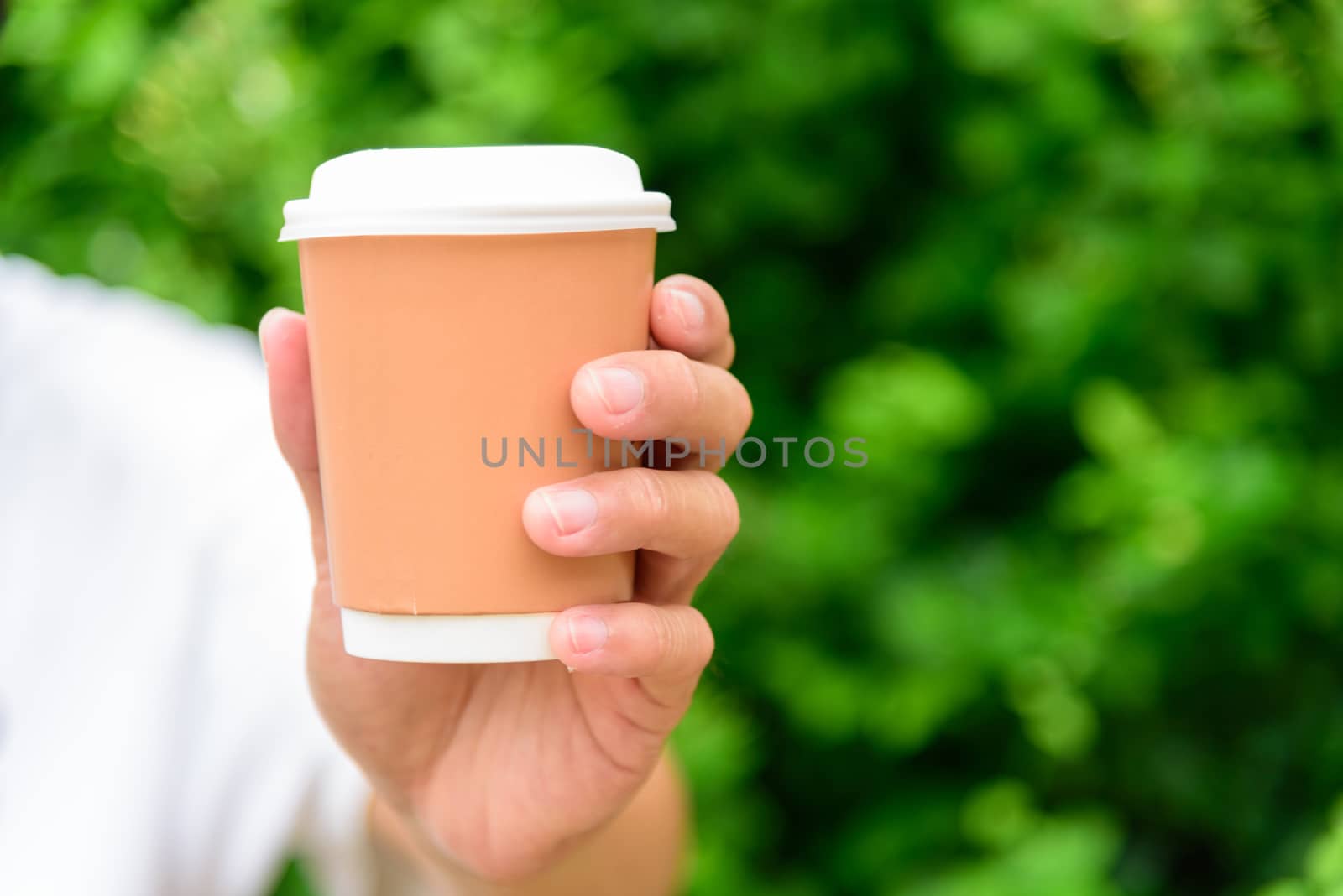 The man hand show a cup of hot coffee