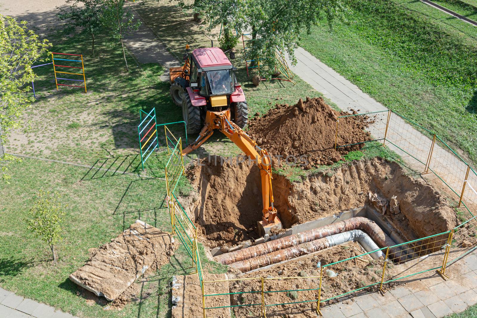 Minsk, Belarus - 12 September 2018: Tractor digs a pit to repair a ruptured heating pipe